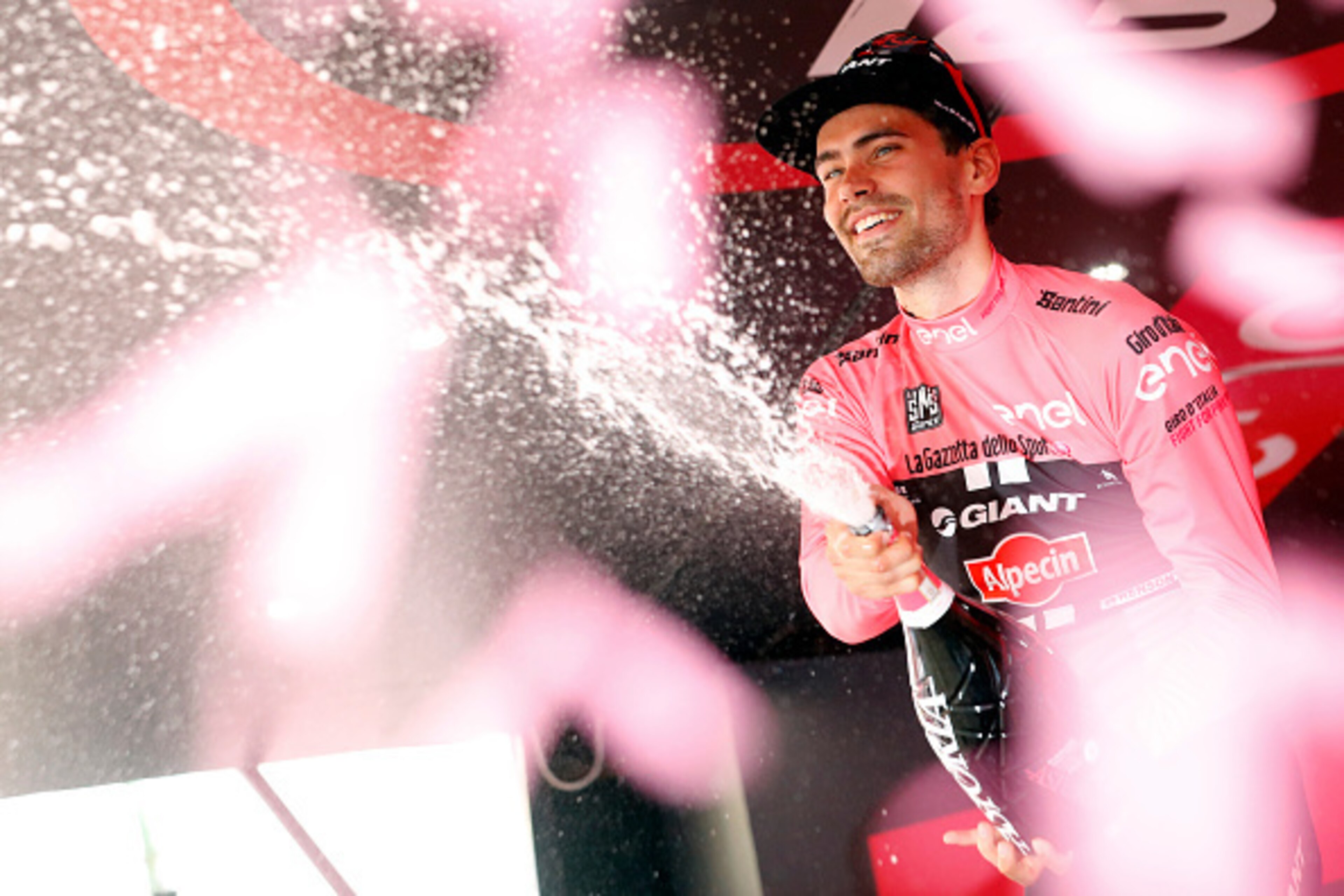 Dutch cyclist Tom Dumoulin of Giant - Alpecin team sprays champagne as he celebrates his overall leader pink jersey on the podium after the 233km fifth stage between Praia a Mare and Benevento, during the 99th Giro d'Italia, Tour of Italy, on May 11, 2016 Dutch cyclist Tom Dumoulin of Giant - Alpecin team sprays champagne as he celebrates his overall leader pink jersey on the podium after the 233km fifth stage between Praia a Mare and Benevento, during the 99th Giro d'Italia, Tour of Italy, on May 11, 2016