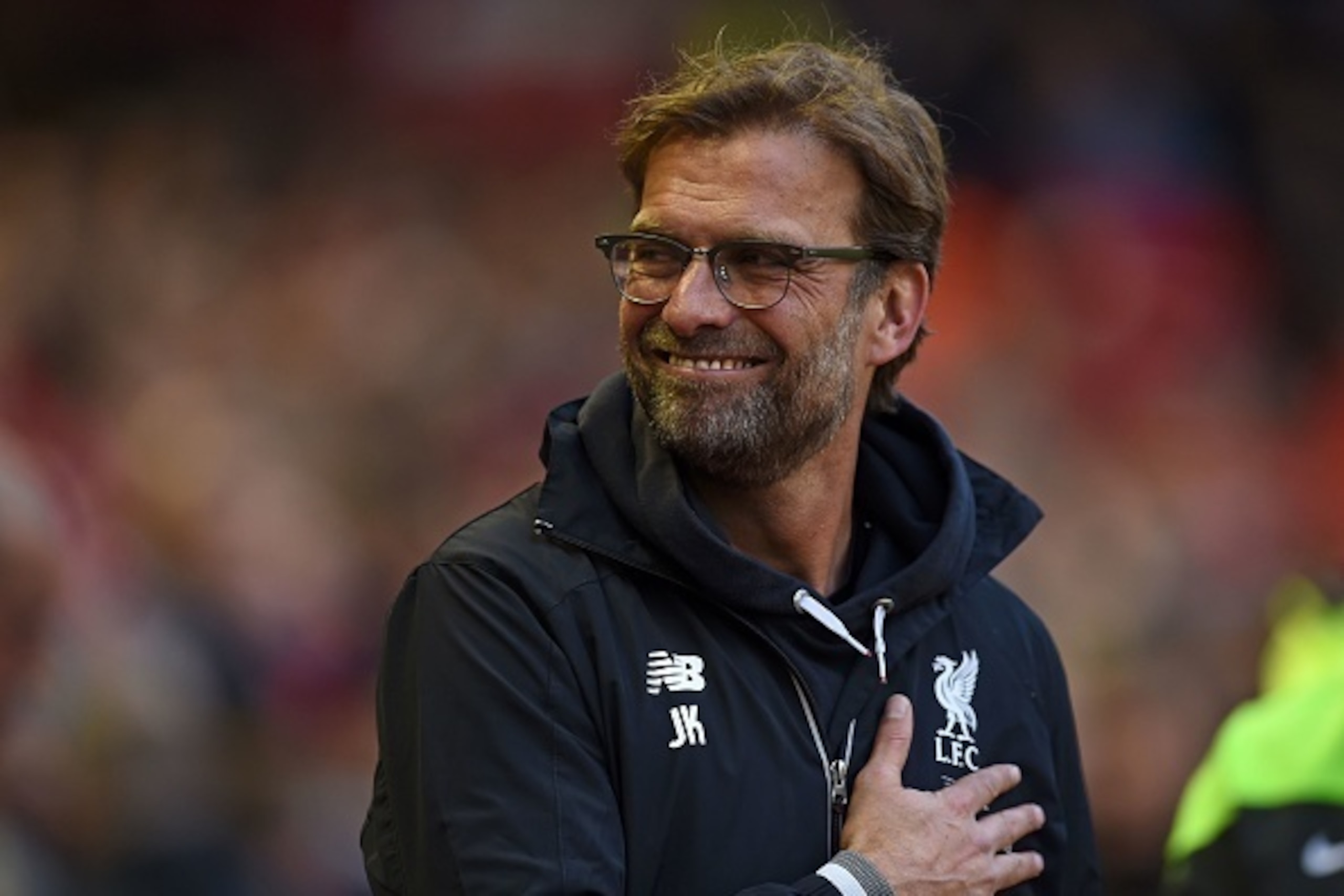 Liverpool's German manager Jurgen Klopp smiles as he waits for kick off in the English Premier League football match between Liverpool and Chelsea at Anfield in Liverpool, north west England on May 11, 2016. / AFP / Paul ELLIS / RESTRICTED TO EDITORIAL US
