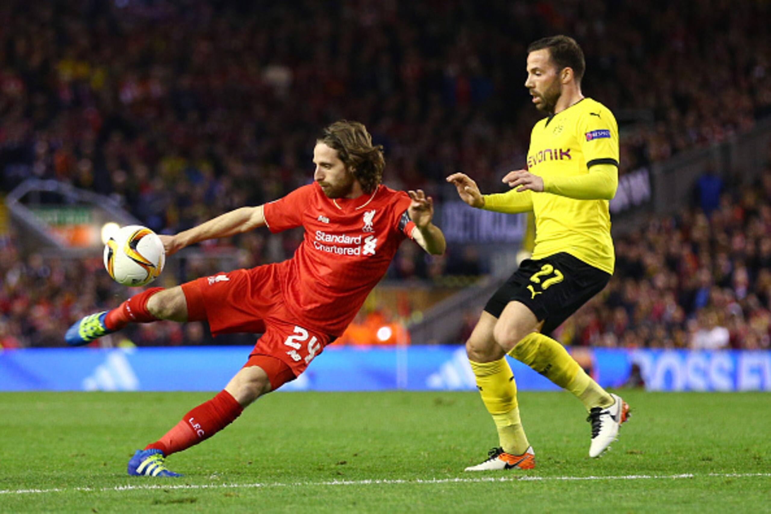 LIVERPOOL, ENGLAND - APRIL 14: Joe Allen of Liverpool shoots with Gonzalo Castro of Borussia Dortmund during the UEFA Europa League quarter final, second leg match between Liverpool and Borussia Dortmund at Anfield on April 14, 2016 in Liverpool, United K