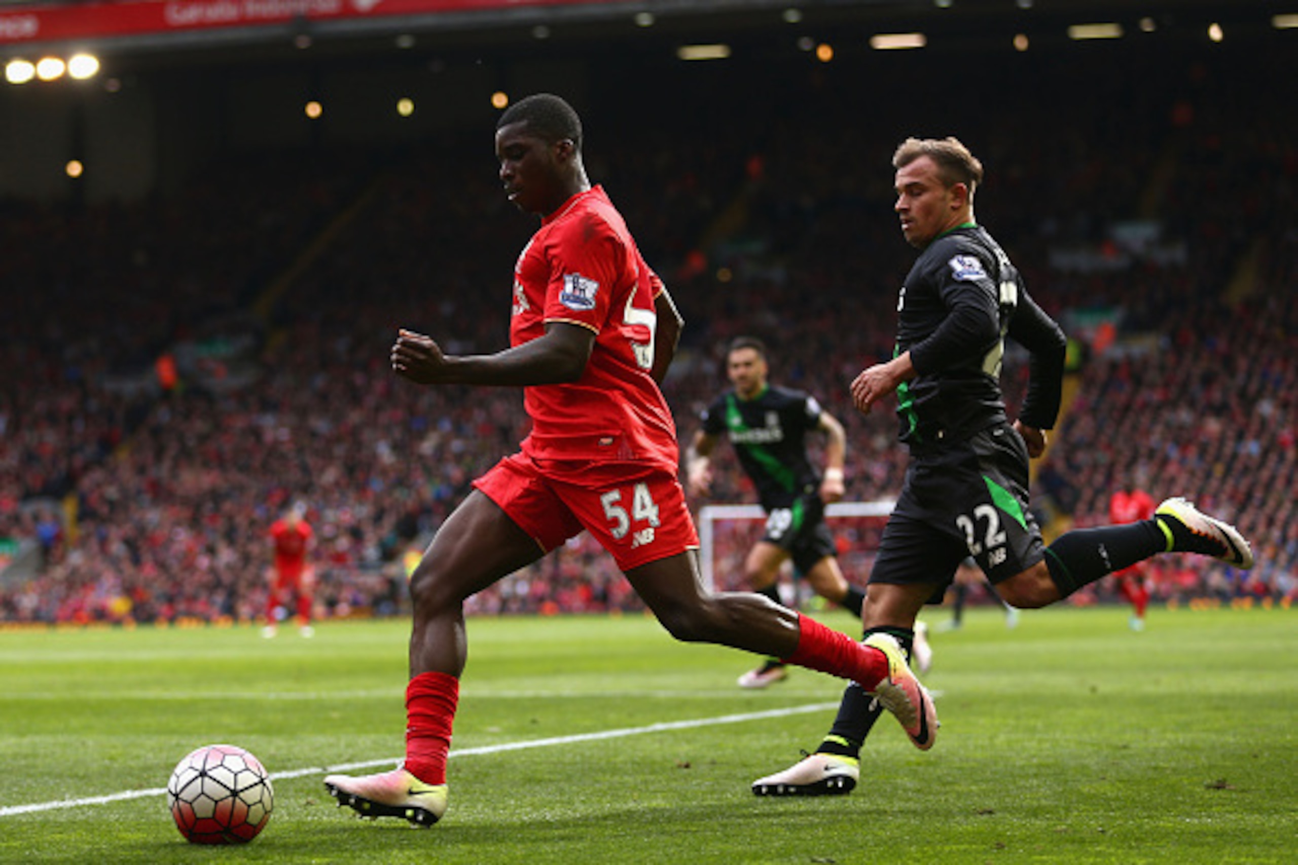 LIVERPOOL, UNITED KINGDOM - APRIL 10:  Sheyi Ojo of Liverpool is chased by Xherdan Shaqiri of Stoke City during the Barclays Premier League match between Liverpool and Stoke City at Anfield on April 10, 2016 in Liverpool, England.  (Photo by Clive Brunski