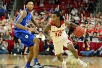 Jan 23, 2016; Raleigh, NC, USA; North Carolina State Wolfpack guard Anthony 'Cat' Barber (12) dribbles around Duke Blue Devils forward Brandon Ingram (14) during the first half at PNC Arena. Mandatory Credit: Rob Kinnan-USA TODAY Sports
