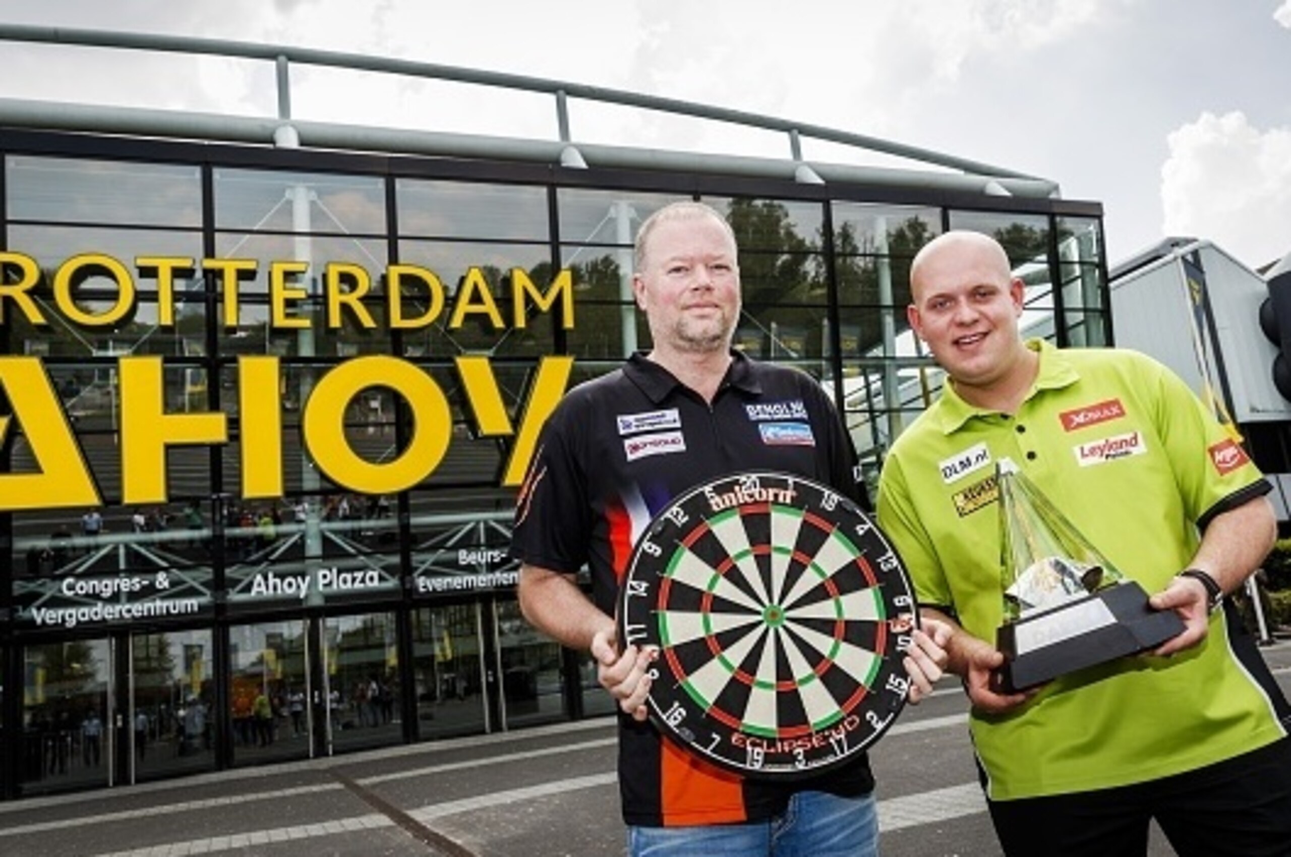 Dutch professional darts players Raymond van Barneveld (L) and Michael van Gerwen pose on May 11, 2016 as part of the press conference of the Premier League Darts in Rotterdam. 
The Premier League Darts is held on May 12 in Ahoy Rotterdam. / AFP / ANP / R