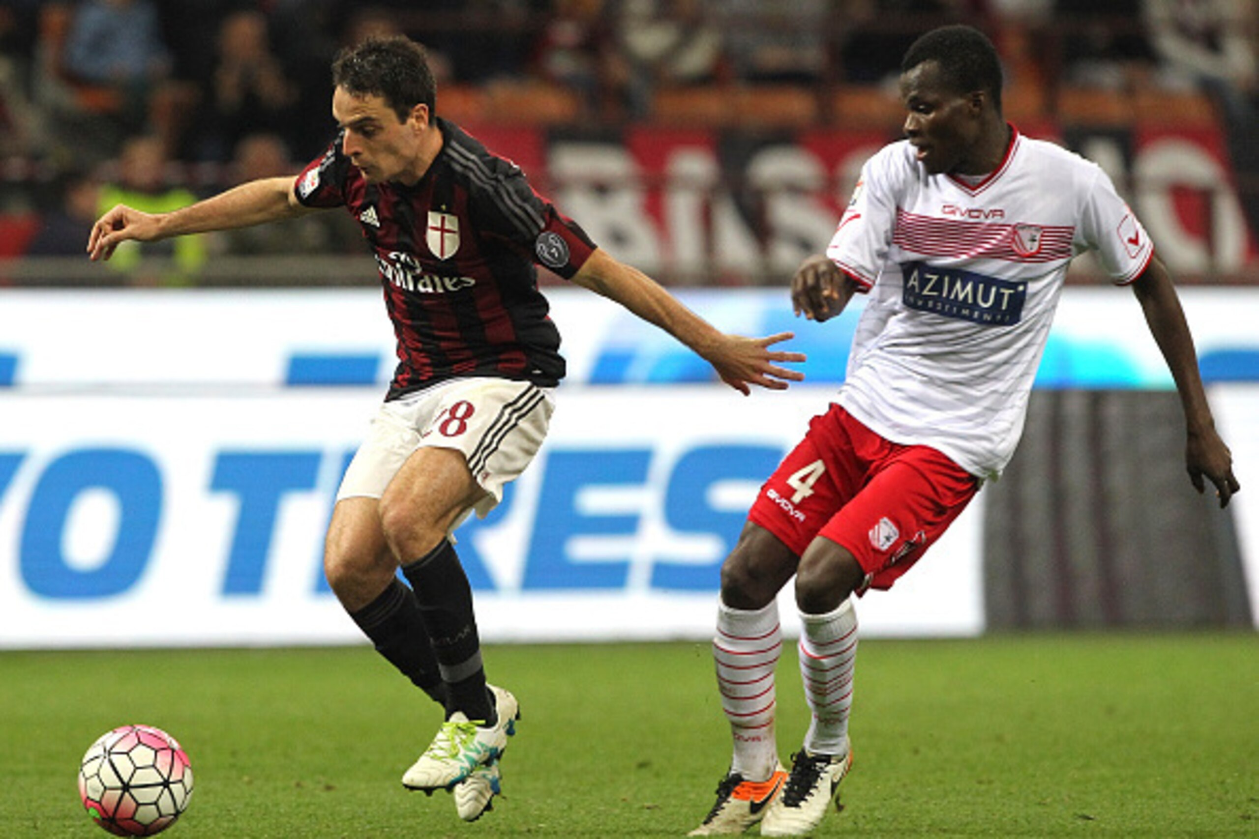 MILAN, ITALY - APRIL 21:  Giacomo Bonaventura of AC Milan is challenged by Isaac Cofie of Carpi FC during the Serie A match between AC Milan and Carpi FC at Stadio Giuseppe Meazza on April 21, 2016 in Milan, Italy.  (Photo by Marco Luzzani/Getty Images)