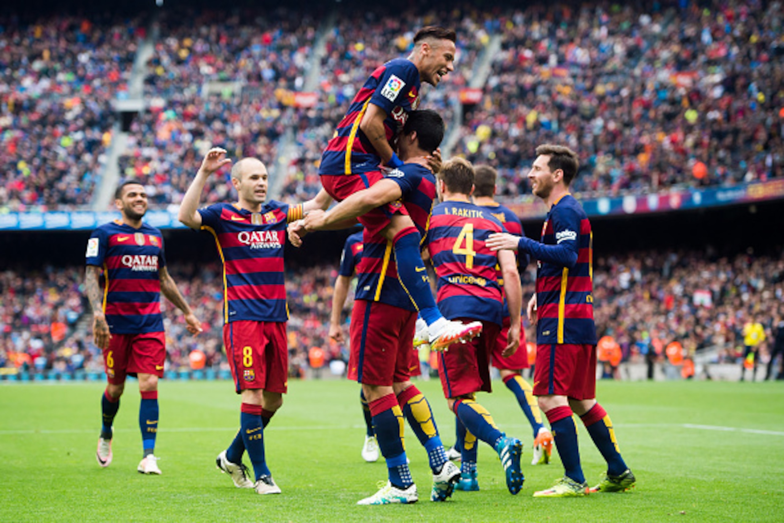 BARCELONA, SPAIN - MAY 08:  (L-R) Dani Alves, Andres Iniesta, Neymar Santos Jr, Ivan Rakitic and Lionel Messi of FC Barcelona celebrate with their teammate Luis Suarez (C) after scoring his team's third goal during the La Liga match between FC Barcelona a