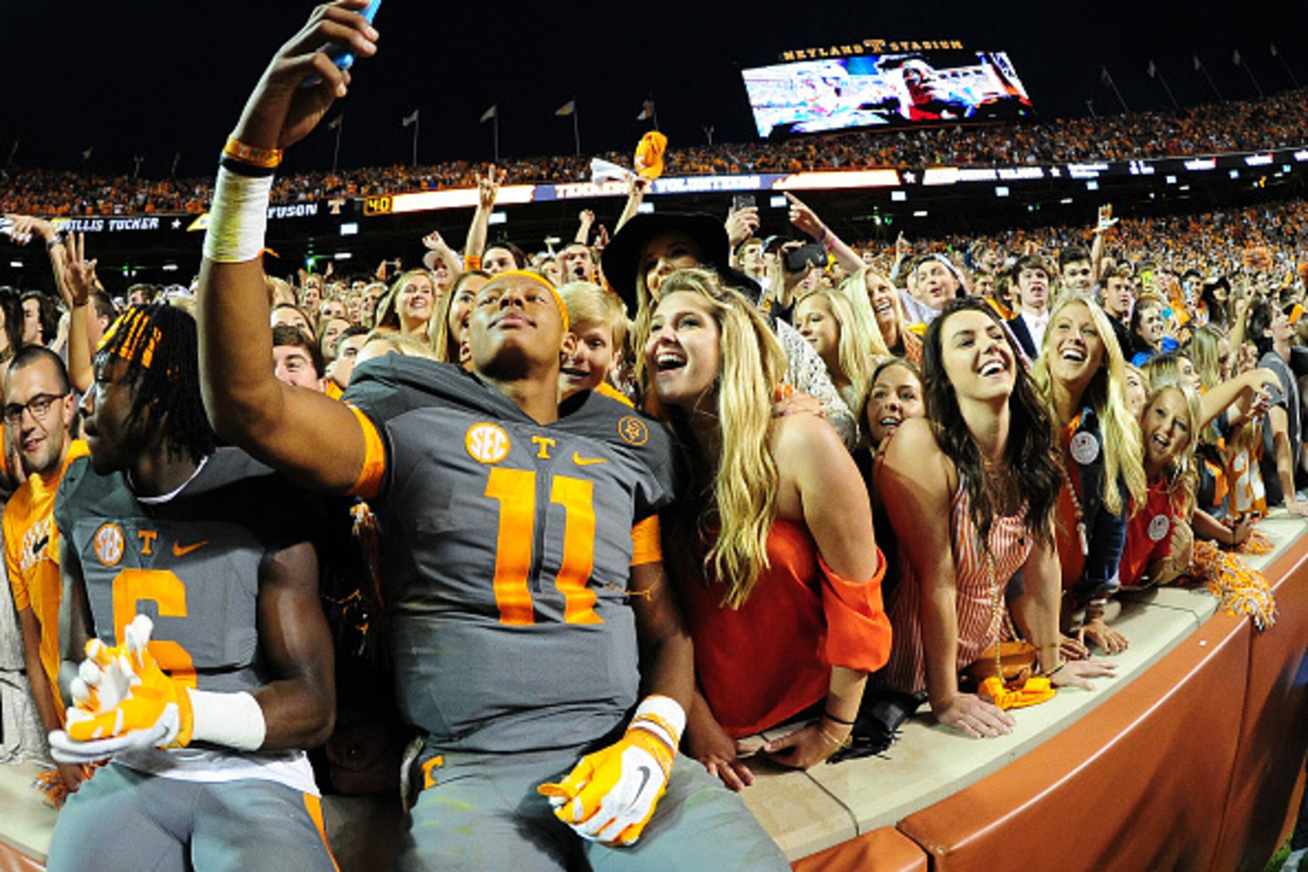 KNOXVILLE, TN - OCTOBER 10: Joshua Dobbs #11 of the Tennessee Volunteers takes a selfie with fans after the game against the Georgia Bulldogs on October 10, 2015 at Neyland Stadium in Knoxville, Tennessee. (Photo by Scott Cunningham/Getty Images)