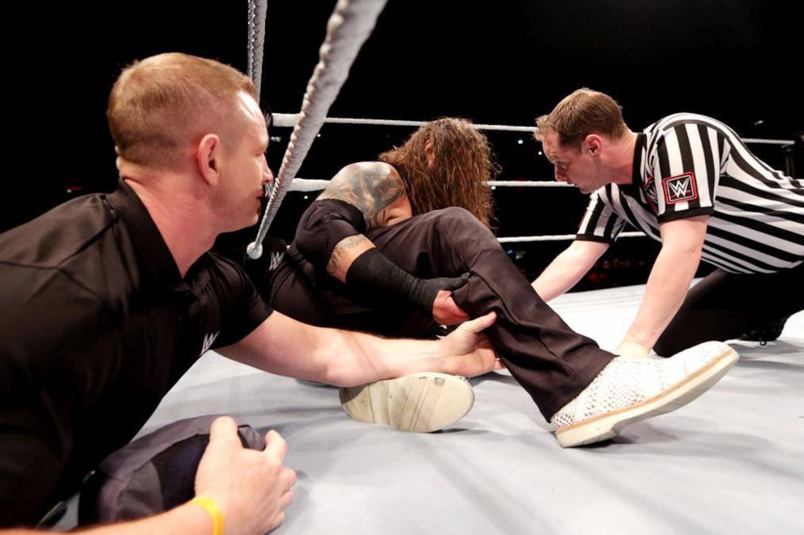Officials tend to an injured Bray Wyatt.