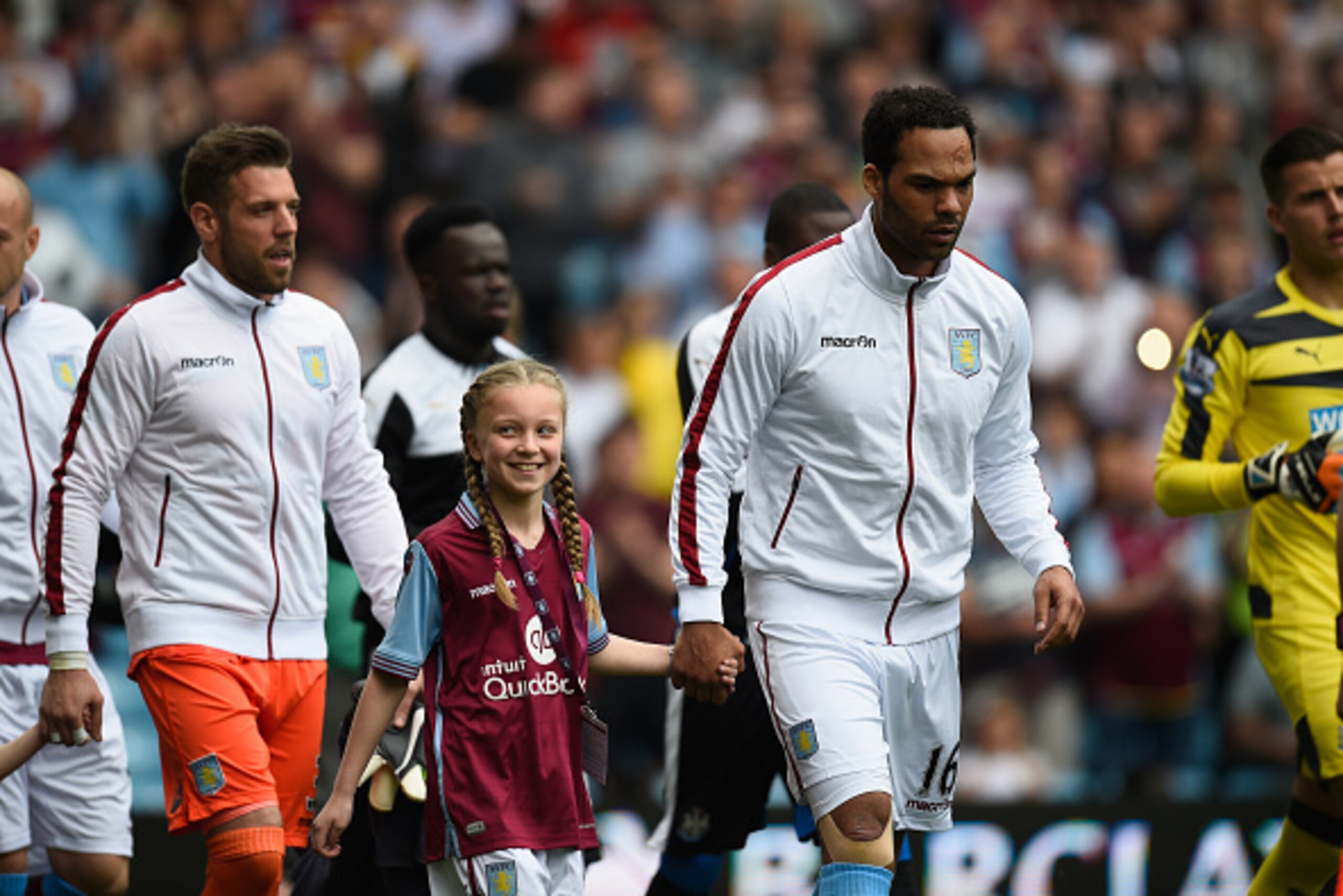 BIRMINGHAM, ENGLAND - MAY 07:  Villa captain Joleon Lescott  and mascott takes the field before the Barclays Premier League match between Aston Villa and Newcastle United at Villa Park on May 7, 2016 in Birmingham, United Kingdom.  (Photo by Stu Forster/G