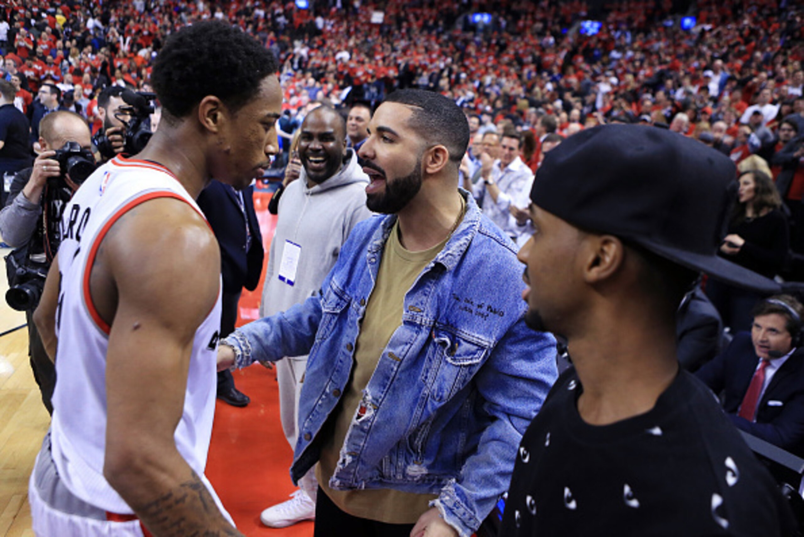 TORONTO, ON - MAY 01:  Singer Drake congratulates DeMar DeRozan #10 of the Toronto Raptors following Game Seven of the Eastern Conference Quarterfinals against the Indiana Pacers during the 2016 NBA Playoffs at the Air Canada Centre on May 01, 2016 in Tor