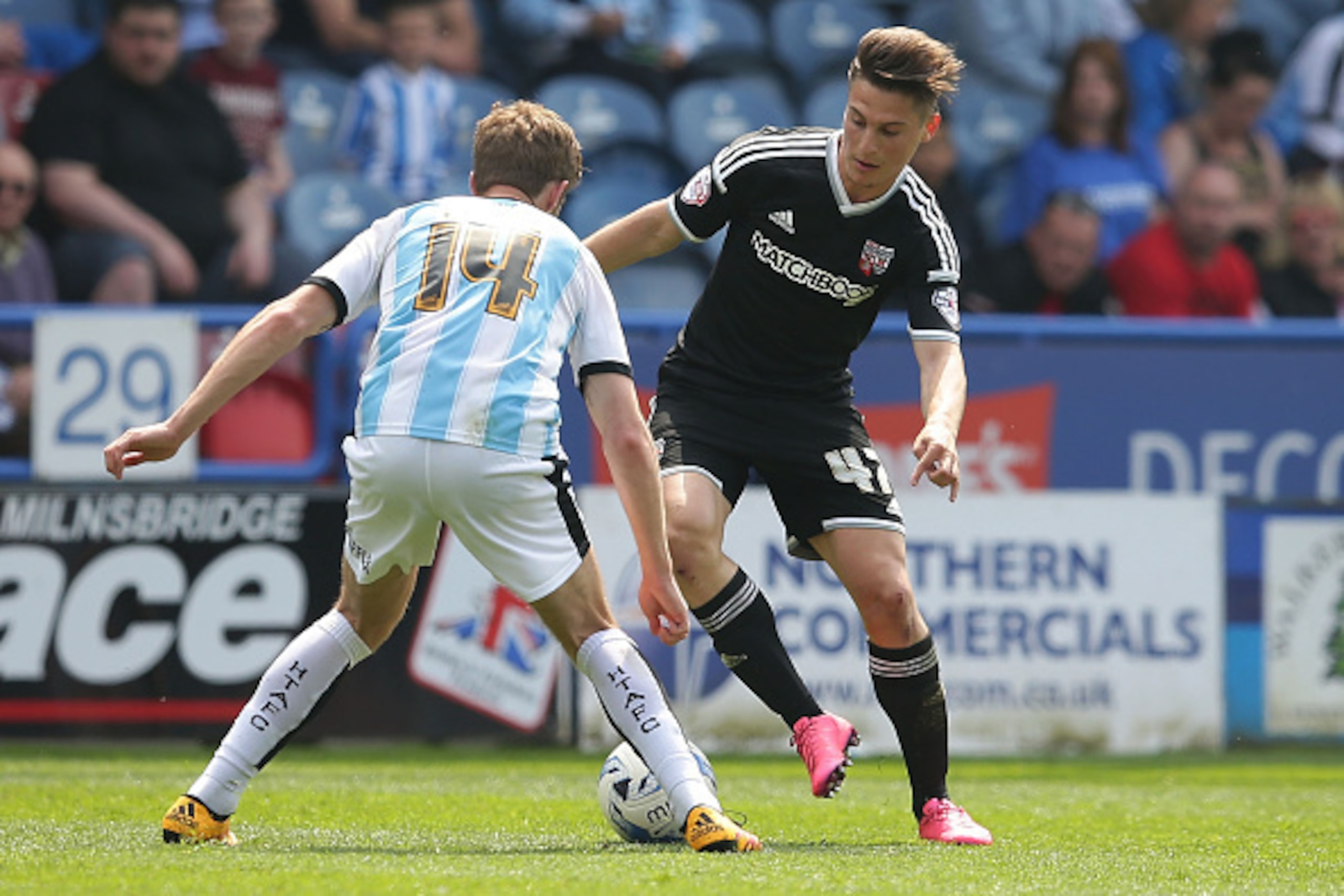HUDDERSFIELD, ENGLAND - MAY 07: Sergi Canos of Brentford FC is opposed by Martin Cranie of Huddersfield Town FC during the Sky Bet Championship match between Huddersfield Town and Brentford at The John Smith's Stadium on May 7, 2016 in Huddersfield, Unite