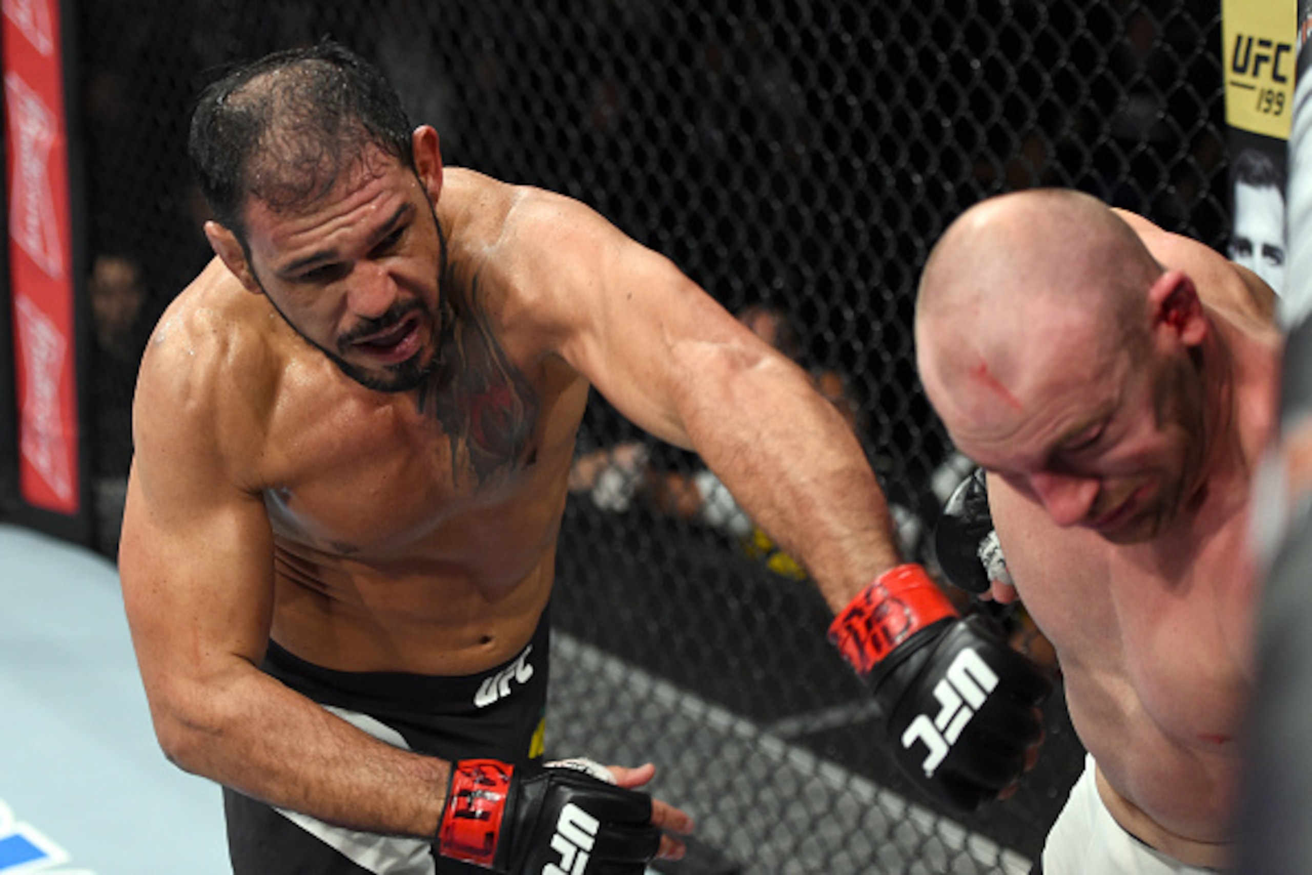 CURITIBA, BRAZIL - MAY 14:  (L-R) Antonio Rogerio Nogueira of Brazil punches Patrick Cummins in their light heavyweight bout during the UFC 198 event at Arena da Baixada stadium on May 14, 2016 in Curitiba, Parana, Brazil.  (Photo by Josh Hedges/Zuffa LLC