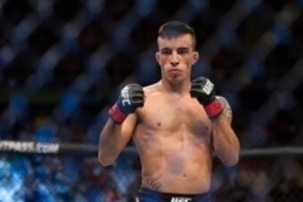 Nov 7, 2015; Sao Paulo, Brazil;  Thomas Almeida (red gloves) reacts after defeating Anthony Birchak (blue gloves) during UFC Fight Night at Ibirapuera Gymnasium. Mandatory Credit: Jason Silva-USA TODAY Sports