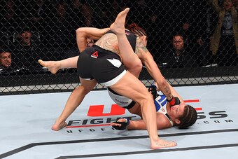 CURITIBA, BRAZIL - MAY 14:  (L-R) Cristiane 'Cyborg' Justino of Brazil punches Leslie Smith in their women's catchweight bout during the UFC 198 event at Arena da Baixada stadium on May 14, 2016 in Curitiba, Parana, Brazil.  (Photo by Josh Hedges/Zuffa LL
