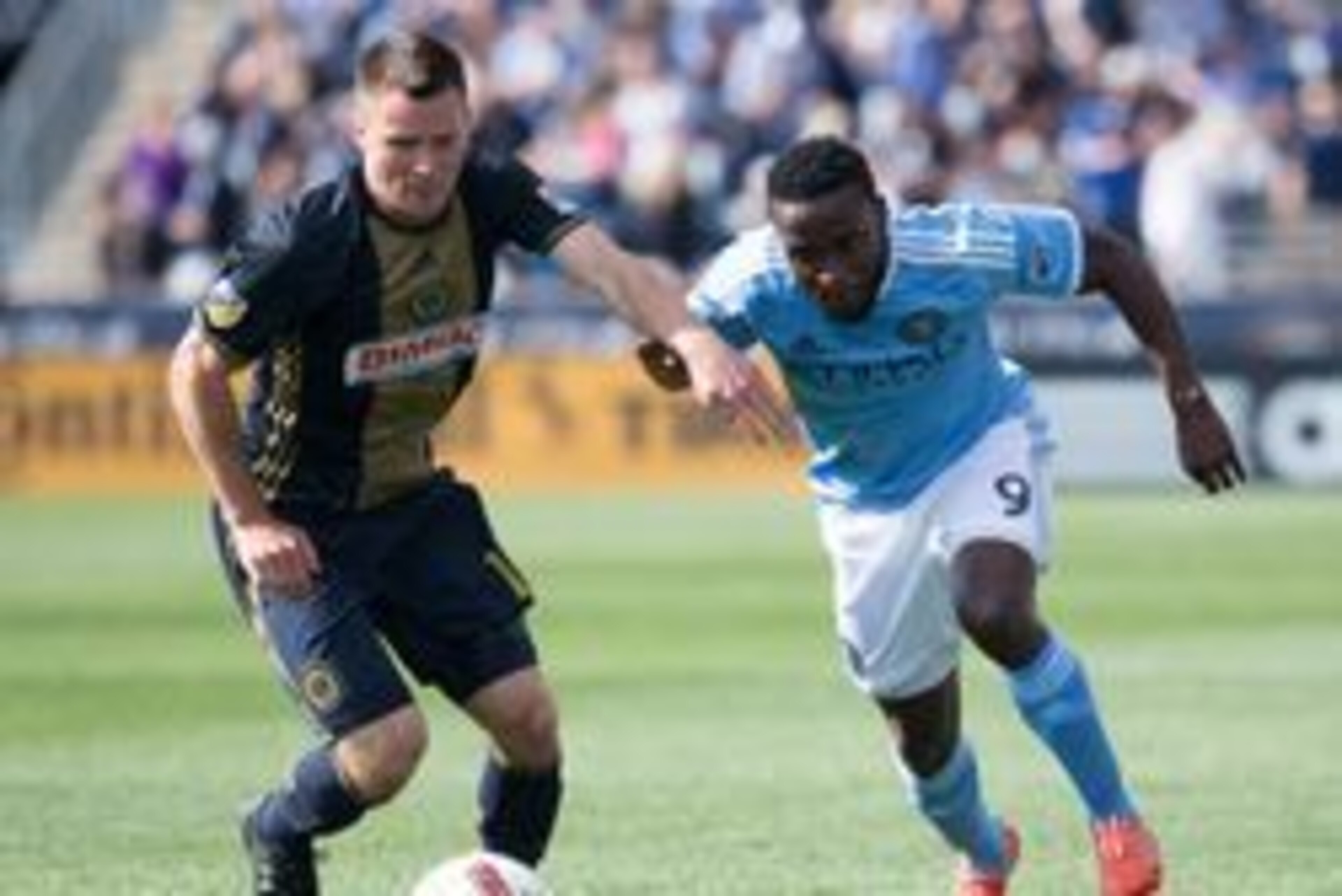 Apr 23, 2016; Philadelphia, PA, USA; Philadelphia Union defender Keegan Rosenberry (12) and New York City FC forward Stiven Mendoza (9) compete for the ball during the first half at Talen Energy Stadium. Mandatory Credit: Bill Streicher-USA TODAY Sports