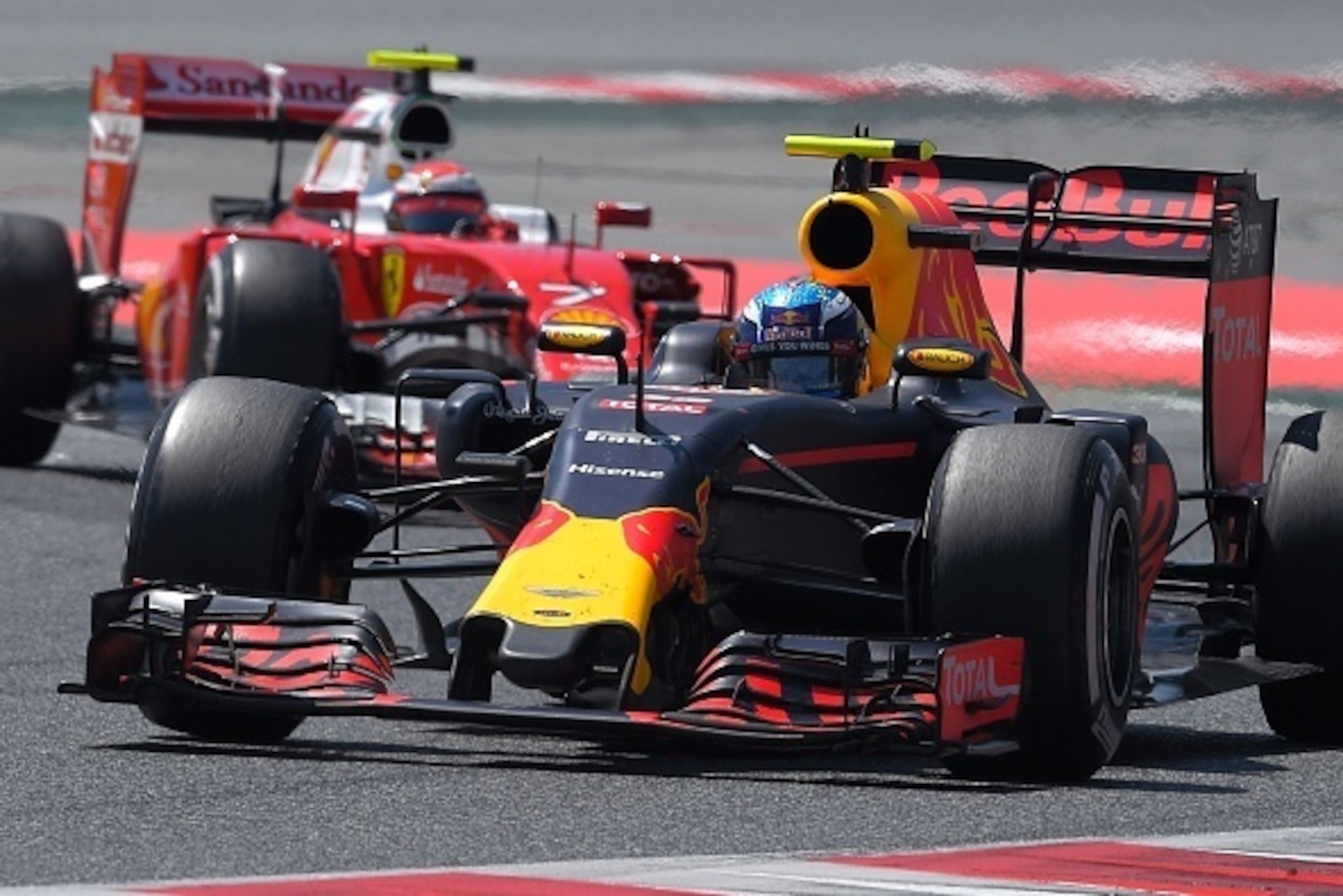 Infiniti Red Bull's Belgian-Dutch driver Max Verstappen (R) competes with Ferrari's Finnish driver Kimi Raikkonen  at the Circuit de Catalunya on May 15, 2016 in Montmelo on the outskirts of Barcelona during the Spanish Formula One Grand Prix. / AFP / LLU