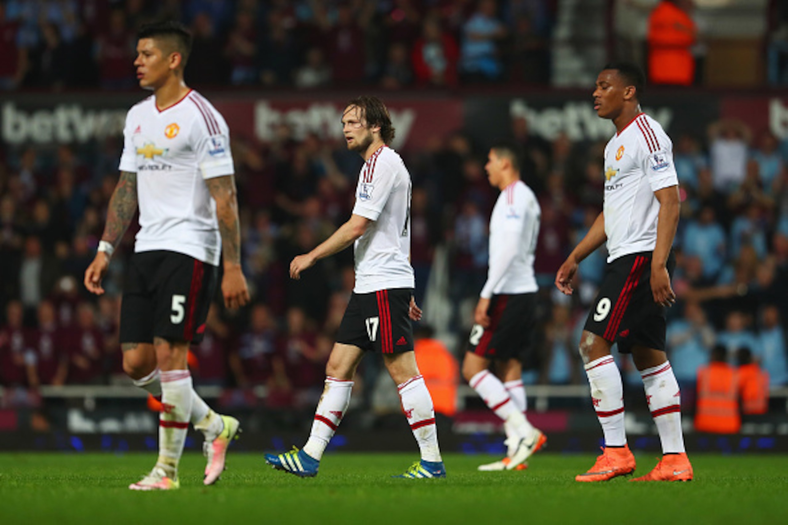 LONDON, ENGLAND - MAY 10:  Despair for Marcos Rojo (5), Daley Blind (17) and Anthony Martial of Manchester United (9) look dejected as Antonio Valencia of Manchester United to scores their second and equalising goal  during the Barclays Premier League mat