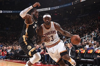 TORONTO, CANADA - NOVEMBER 25:  LeBron James #23 of the Cleveland Cavaliers handles the ball against DeMarre Carroll #5 of the Toronto Raptors on November 25, 2015 at the Air Canada Centre in Toronto, Ontario, Canada.  NOTE TO USER: User expressly acknowl