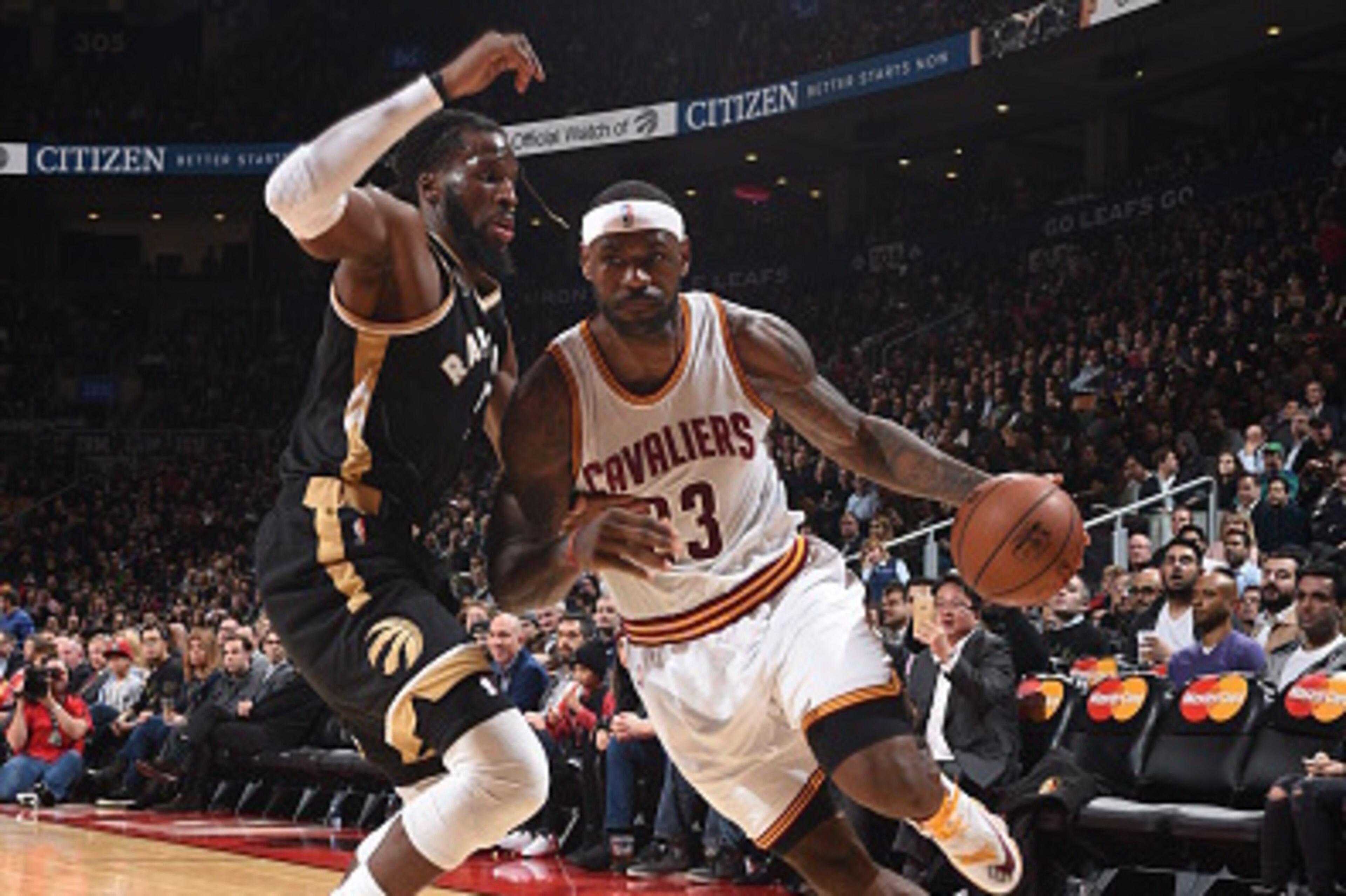 TORONTO, CANADA - NOVEMBER 25:  LeBron James #23 of the Cleveland Cavaliers handles the ball against DeMarre Carroll #5 of the Toronto Raptors on November 25, 2015 at the Air Canada Centre in Toronto, Ontario, Canada.  NOTE TO USER: User expressly acknowl