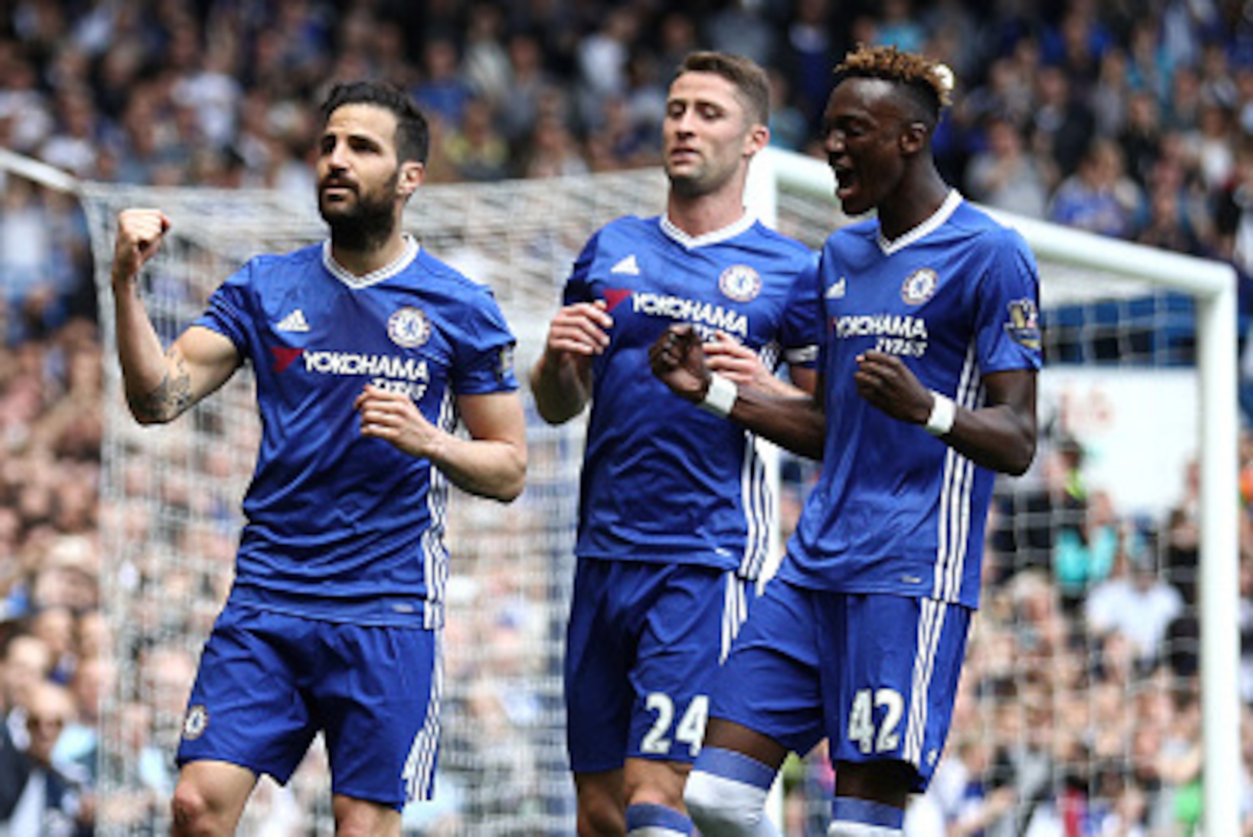 LONDON, ENGLAND - MAY 15:  Sesc Fabregas (L) of Chelsea celebrates scoring his team's first goal with his team mates Gary Cahill (C) and Tammy Abraham (R) during the Barclays Premier League match between Chelsea and Leicester City at Stamford Bridge on Ma