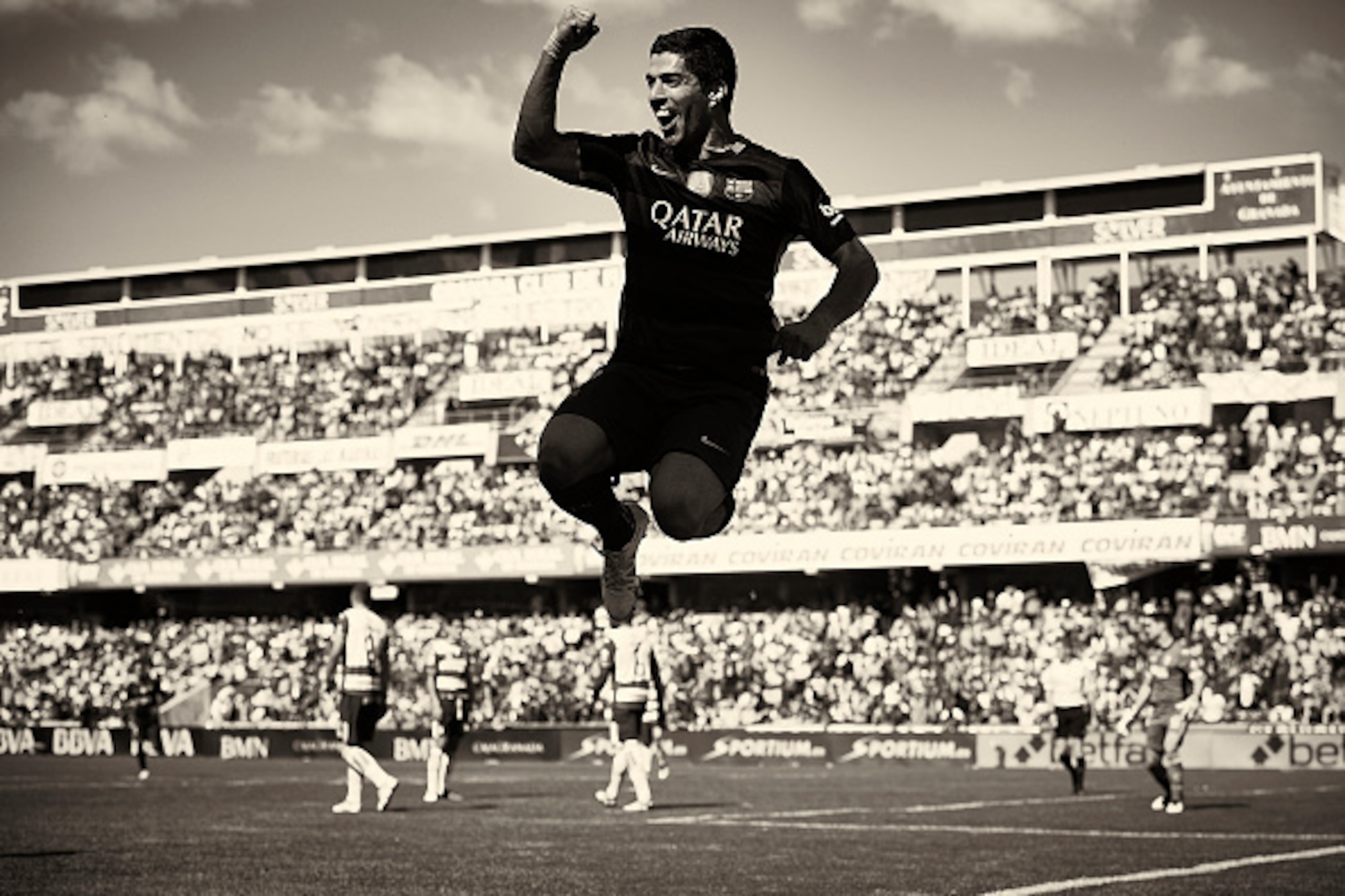 GRANADA, SPAIN - MAY 14:  (EDITORS NOTE: This image has been processed using digitals filters.)  Luis Suarez of FC Barcelona celebrates scoring his team's second during the La Liga match between Granada CF and FC Barcelona at Estadio Nuevo Los Carmenes on