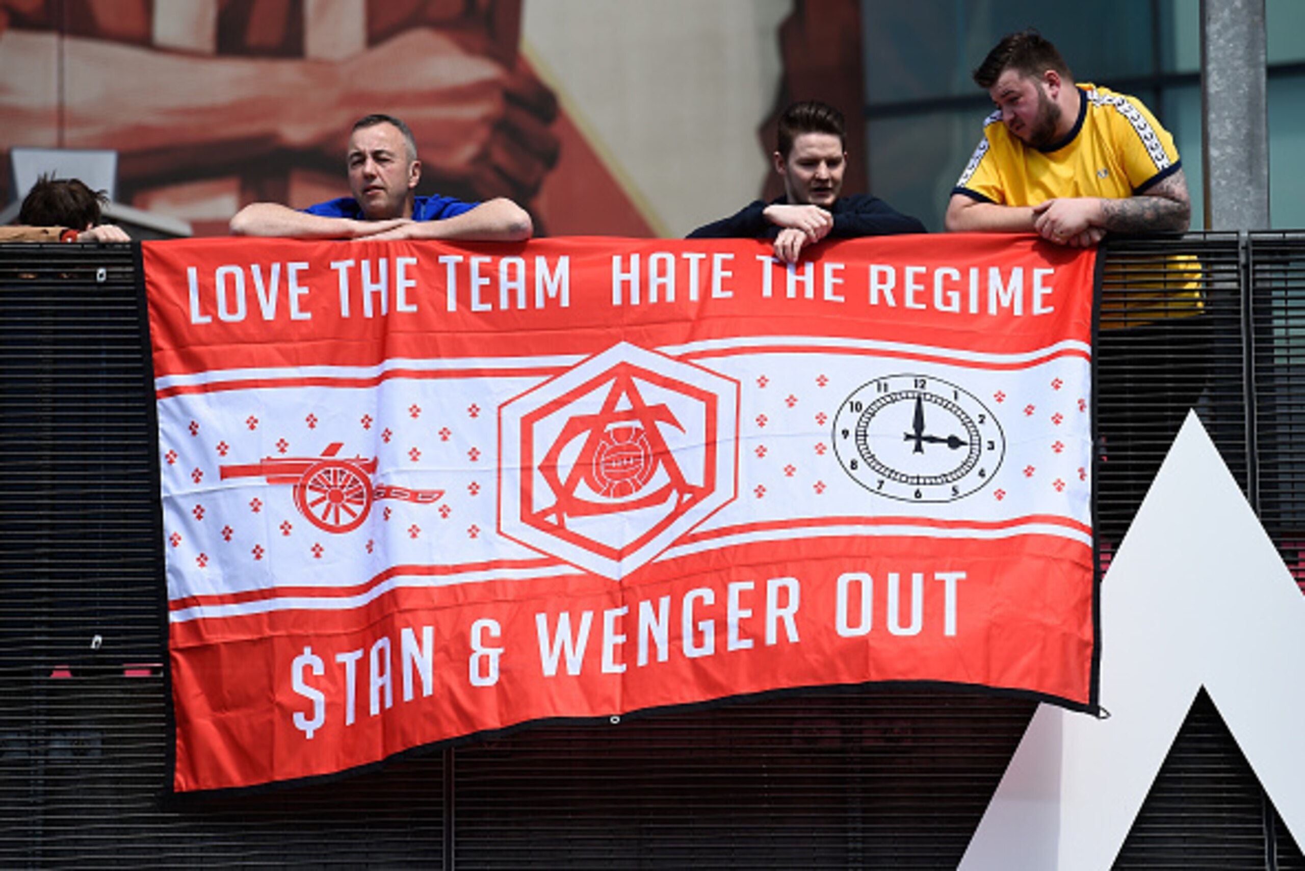 LONDON, UNITED KINGDOM - MAY 15:  Supporters hold a banner to protest against owner Stan Kroenke and manager Arsene Wenger prior to the Barclays Premier League match between Arsenal and Aston Villa at Emirates Stadium on May 15, 2016 in London, England.  