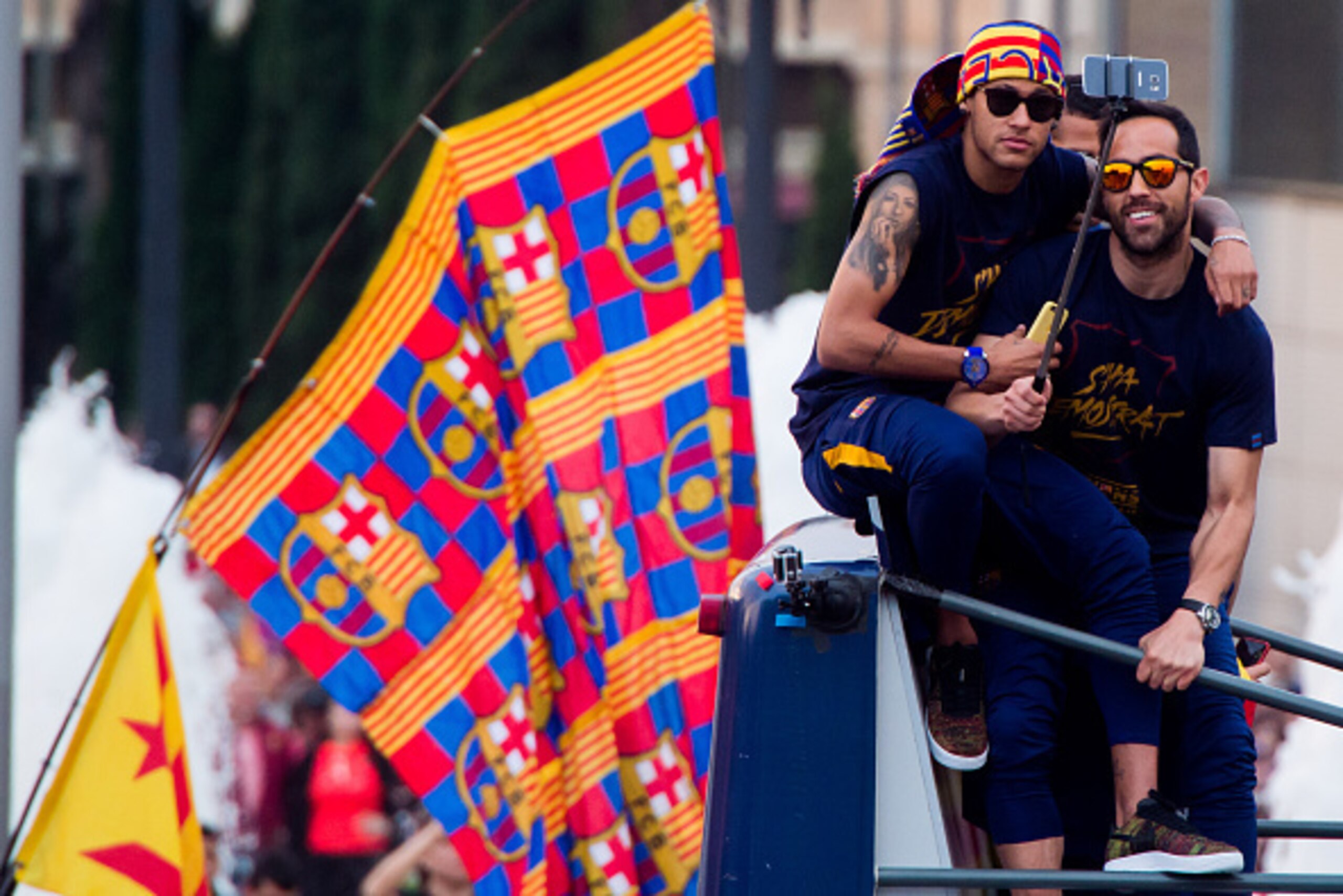 BARCELONA, SPAIN - MAY 15:  Neymar Santos Jr and Claudio Bravo (R) of FC Barcelona take a selfie as they celebrate on an open top bus during their victory parade after winning the Spanish La Liga on May 15, 2016 in Barcelona, Spain.  (Photo by Alex Caparr