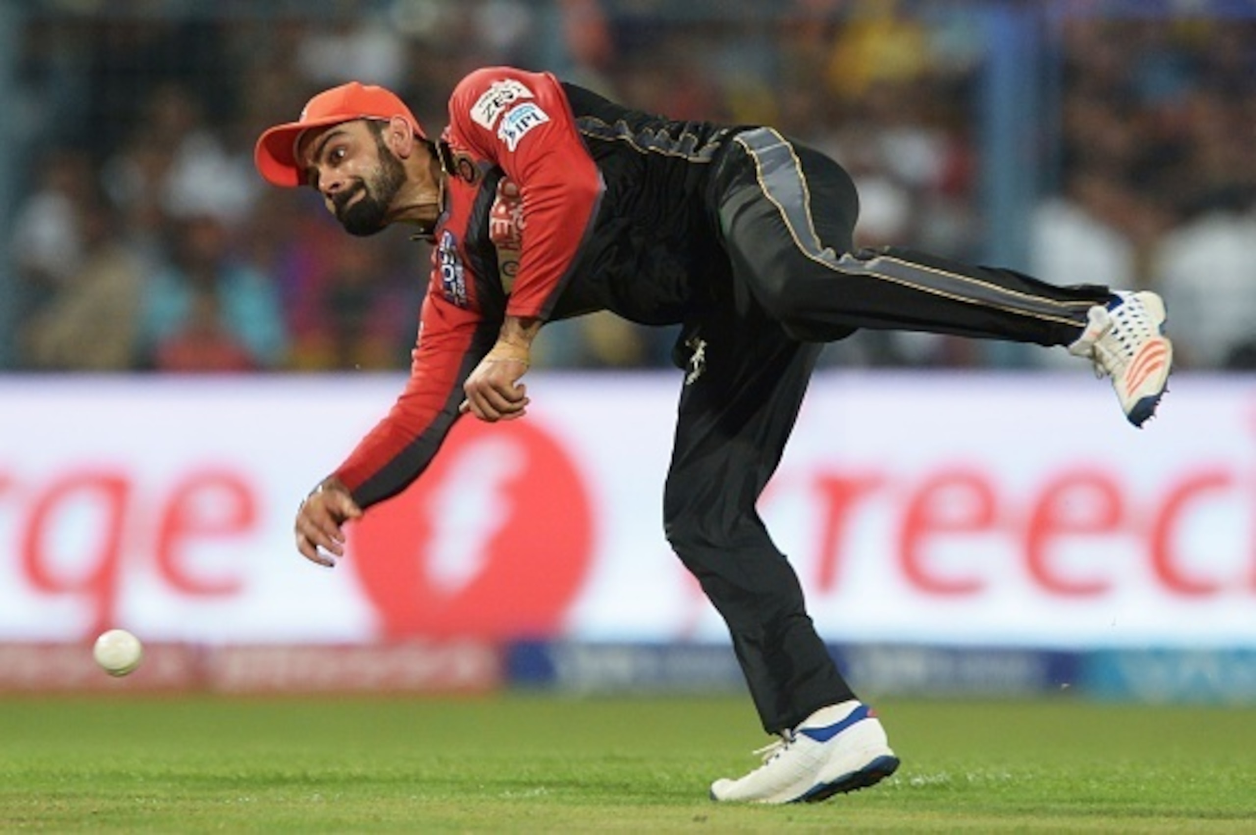 Royal Challengers Bangalore captain Virat Kohli fields the ball during the 2016 Indian Premier League (IPL) Twenty20 cricket match between Kolkata Knight Riders and Royal Challengers Bangalore at the Eden Gardens Cricket Stadium in Kolkata on May 16, 2016