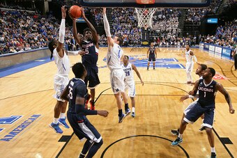 MEMPHIS, TN - FEBRUARY 19: Daniel Hamilton #5 of the Connecticut Huskies drives to the basket for a layup against Austin Nichols #4 of the Memphis Tigers on February 19, 2015 at FedExForum in Memphis, Tennessee. Memphis defeated Connecticut 75-72. (Photo 