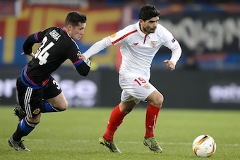 Sevilla's Argentinian midfielder Ever Banega (R) and Basel's Swiss midfielder Taulant Xhaka vies during the UEFA Europa League round of 16 first leg football match between FC Basel and Sevilla FC at the St Jakob Stadium, on March 10, 2016 in Basel.  / AFP