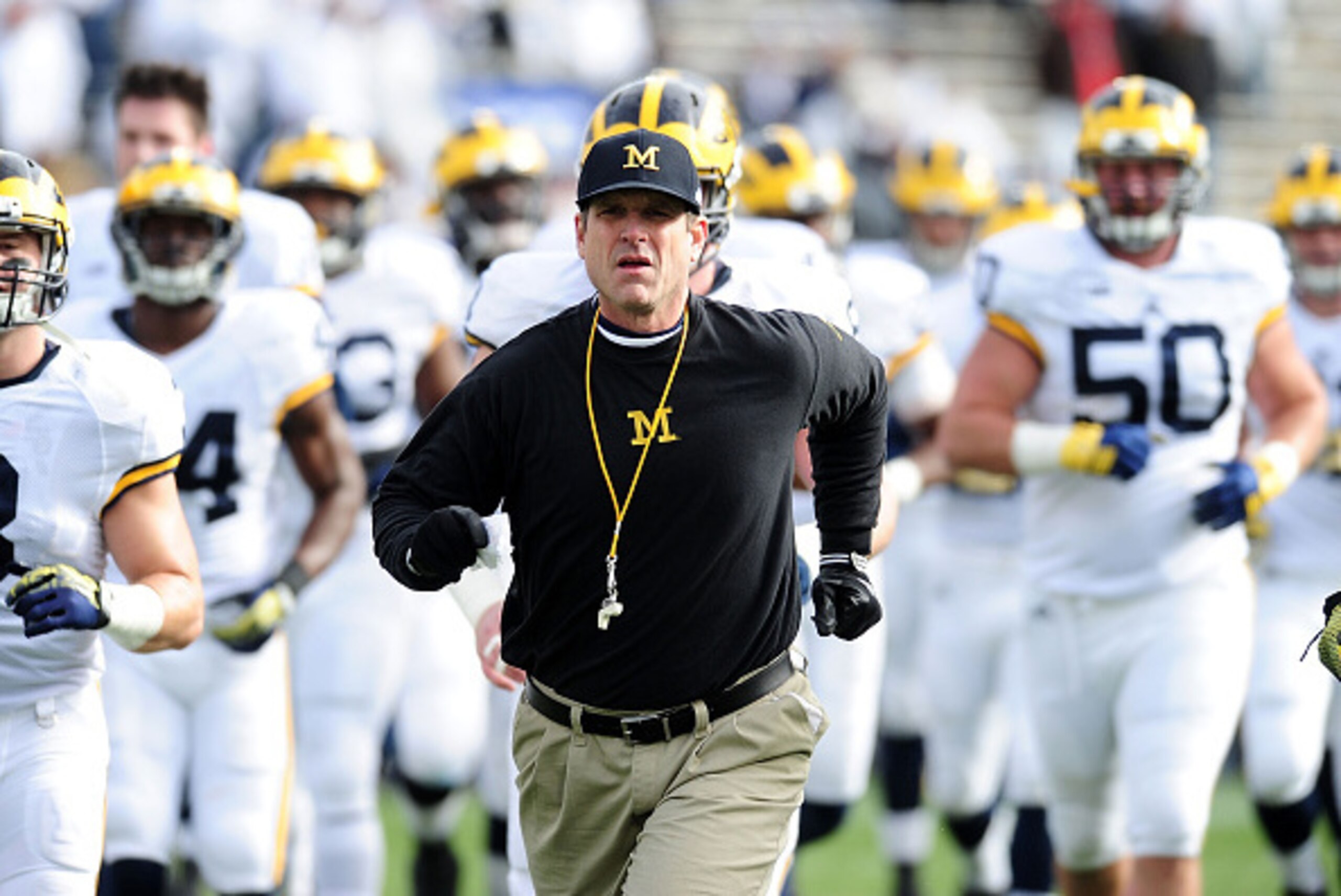 STATE COLLEGE, PA - NOVEMBER 21:  Jim Harbaugh head coach of the Michigan Wolverines run onto the field prior to the game against the Penn State Nittany Lions at Beaver Stadium on November 21, 2015 in State College, Pennsylvania.  (Photo by Evan Habeeb/Ge