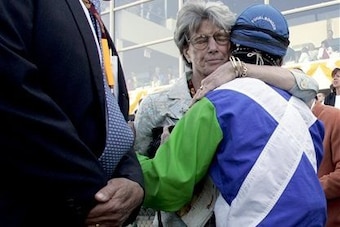 Gretchen Jackson hugs Edgar Prado after Barbaro's injury at the Preakness.