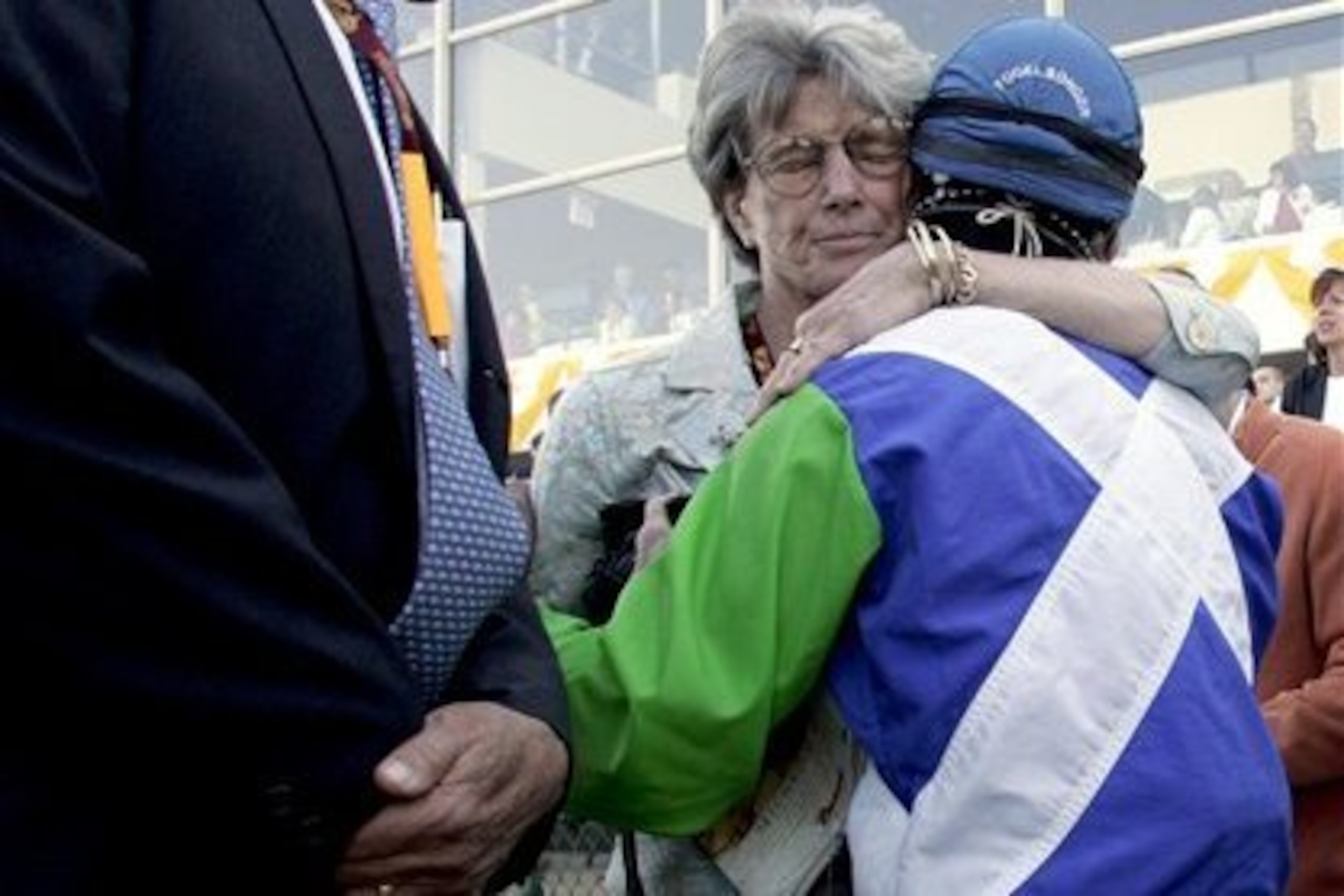 Gretchen Jackson hugs Edgar Prado after Barbaro's injury at the Preakness.