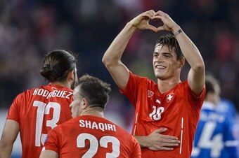 Switzerland's midfielder Granit Xhaka (R) celebrates with teammates Ricardo Rodriguez (L) and Xherdan Shaqiri after scoring his team's second goal during the Euro 2016 qualifying group E football match between Switzerland and Estonia at the Swissporarena 
