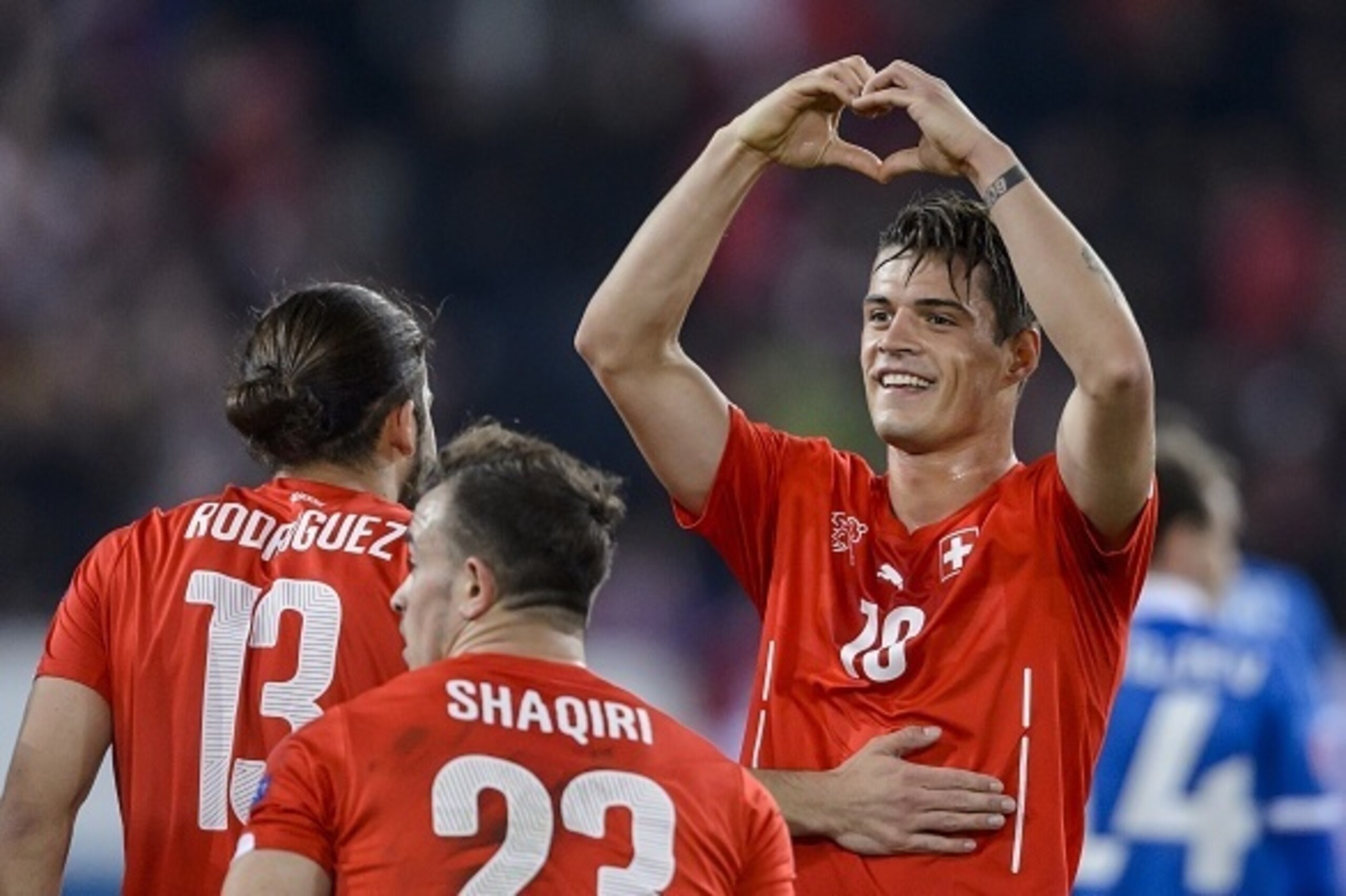 Switzerland's midfielder Granit Xhaka (R) celebrates with teammates Ricardo Rodriguez (L) and Xherdan Shaqiri after scoring his team's second goal during the Euro 2016 qualifying group E football match between Switzerland and Estonia at the Swissporarena Switzerland's midfielder Granit Xhaka (R) celebrates with teammates Ricardo Rodriguez (L) and Xherdan Shaqiri after scoring his team's second goal during the Euro 2016 qualifying group E football match between Switzerland and Estonia at the Swissporarena