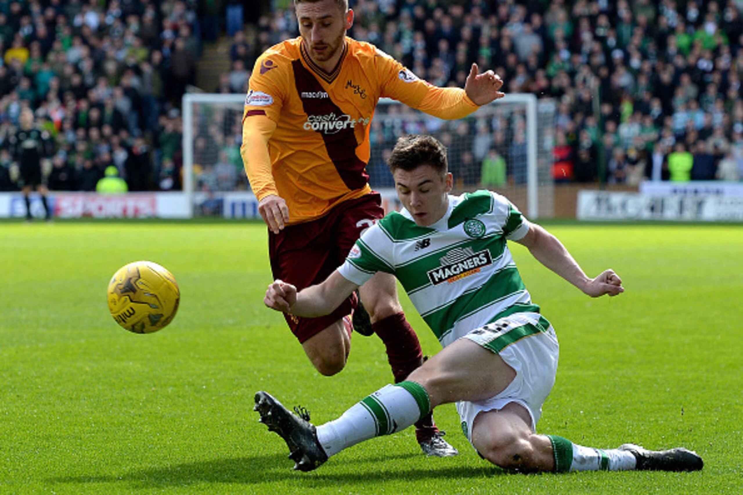 MOTHERWELL, SCOTLAND - APRIL 9 : Kieran Tierney of Celtic is tackled by Louis Moult of Motherwell during the Ladbrokes Scottish Premiership match between Celtic FC and Motherwell FC at Fir Park on April 9, 2016 in Glasgow, Scotland. (Photo by Mark Runnacl