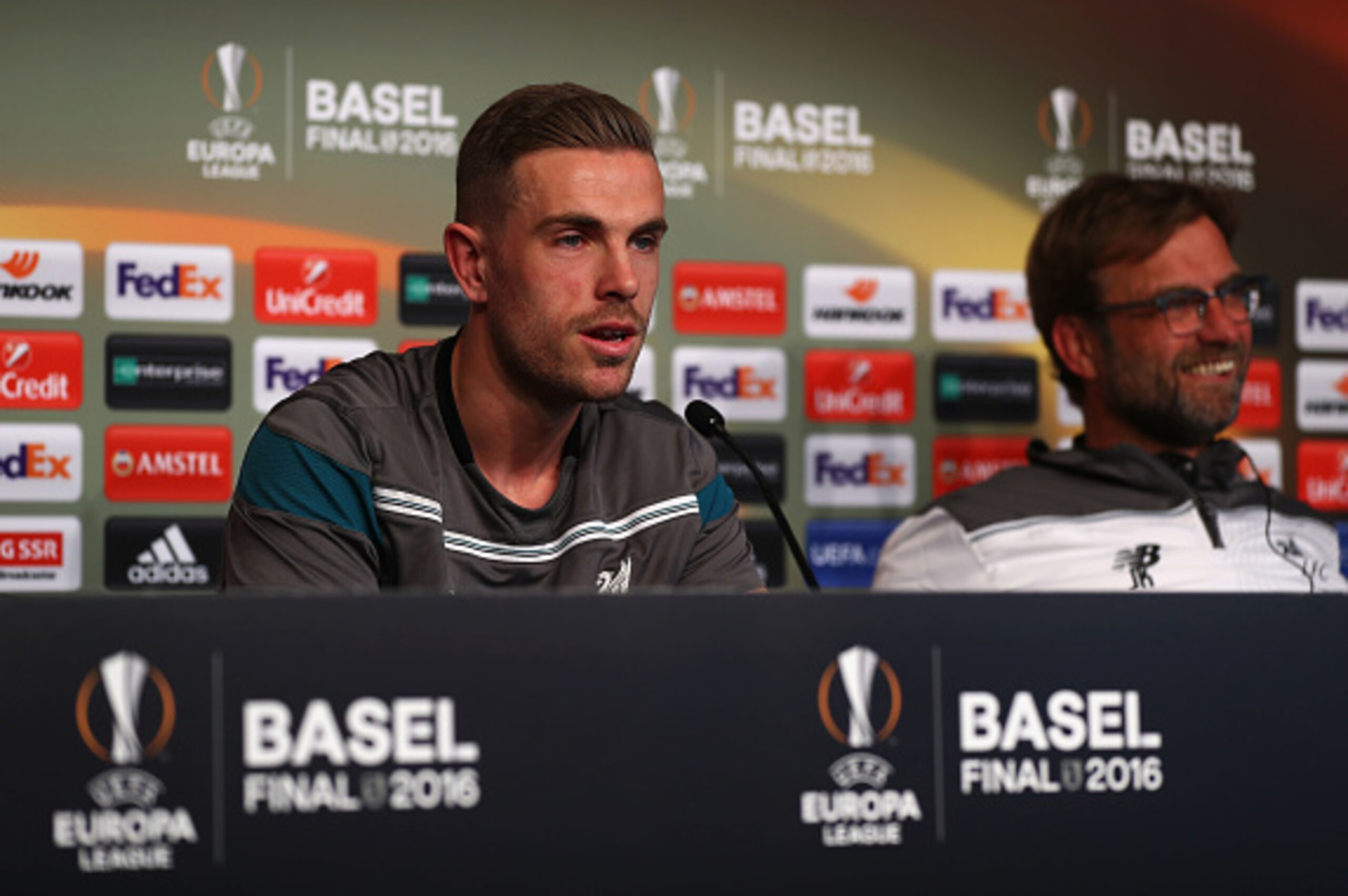 BASEL, SWITZERLAND - MAY 17:  In this handout image provided by UEFA, Jordan Henderson and manager Jurgen Klopp talk during a Liverpool press conference on the eve of the UEFA Europa League Final against Sevilla at St. Jakob-Park on May 17, 2016 in Basel,