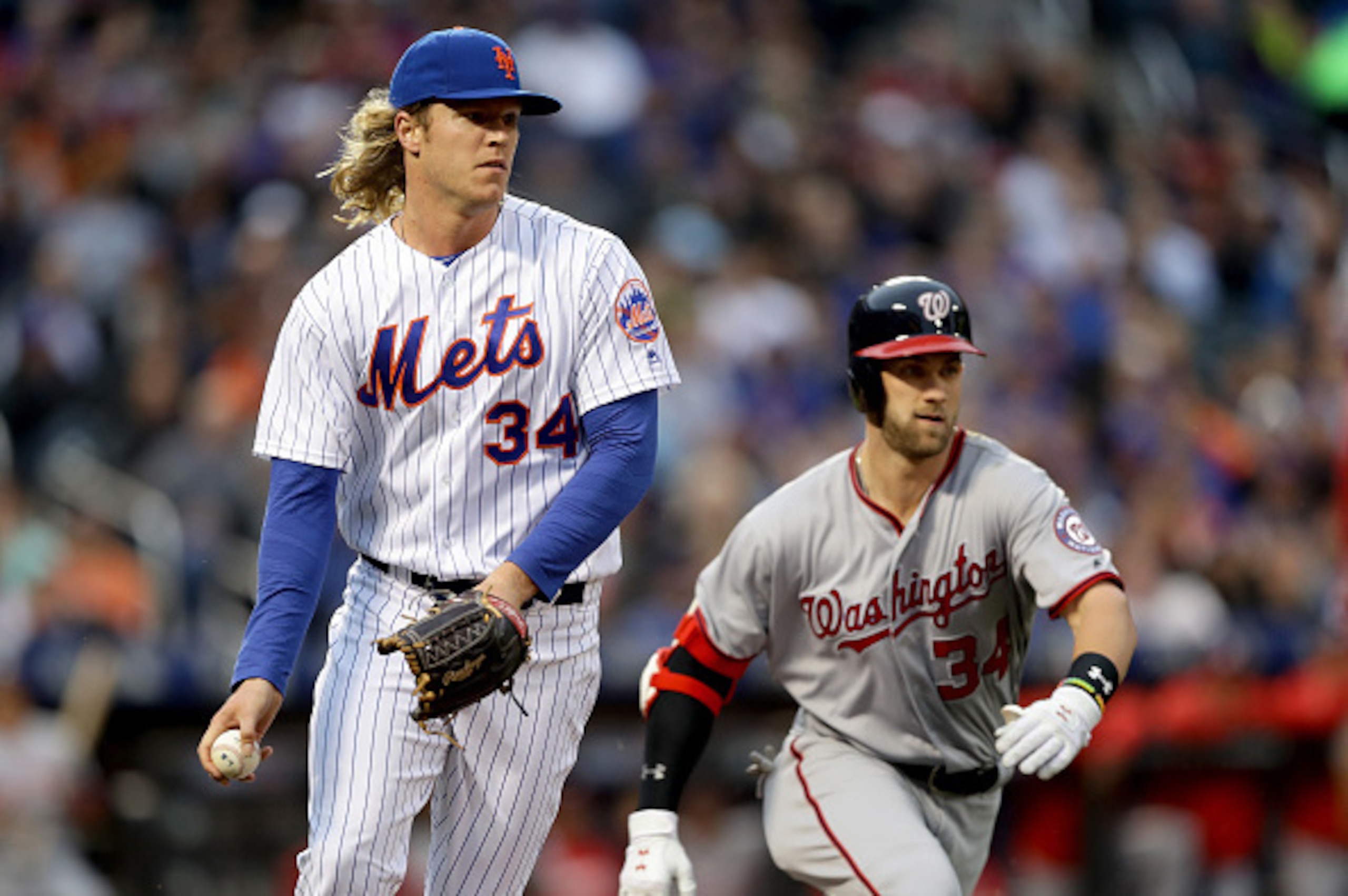 NEW YORK, NY - MAY 17:  Noah Syndergaard #34 of the New York Mets fields a hit by Bryce Harper #34 of the Washington Nationals in the first inning at Citi Field on May 17, 2016 in the Flushing neighborhood of the Queens borough of New York City.  (Photo b