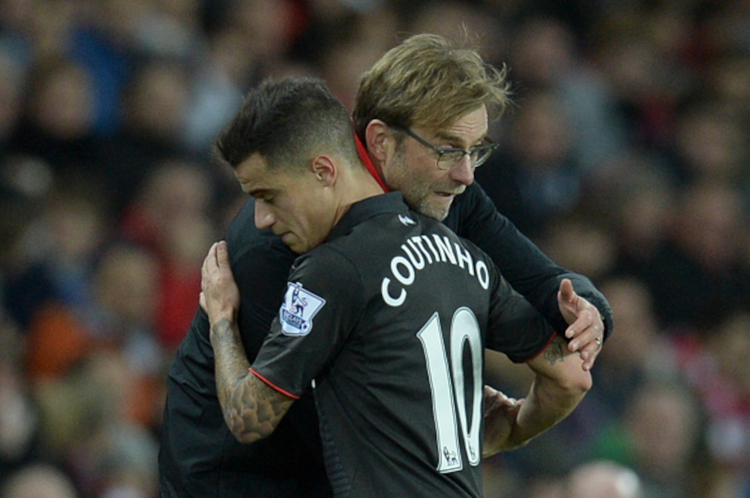 Liverpool's German manager Jurgen Klopp (R) hugs Liverpool's Brazilian midfielder Philippe Coutinho (L) as Coutinho leaves the field after being substituted during the English Premier League football match between Sunderland and Liverpool at the Stadium o