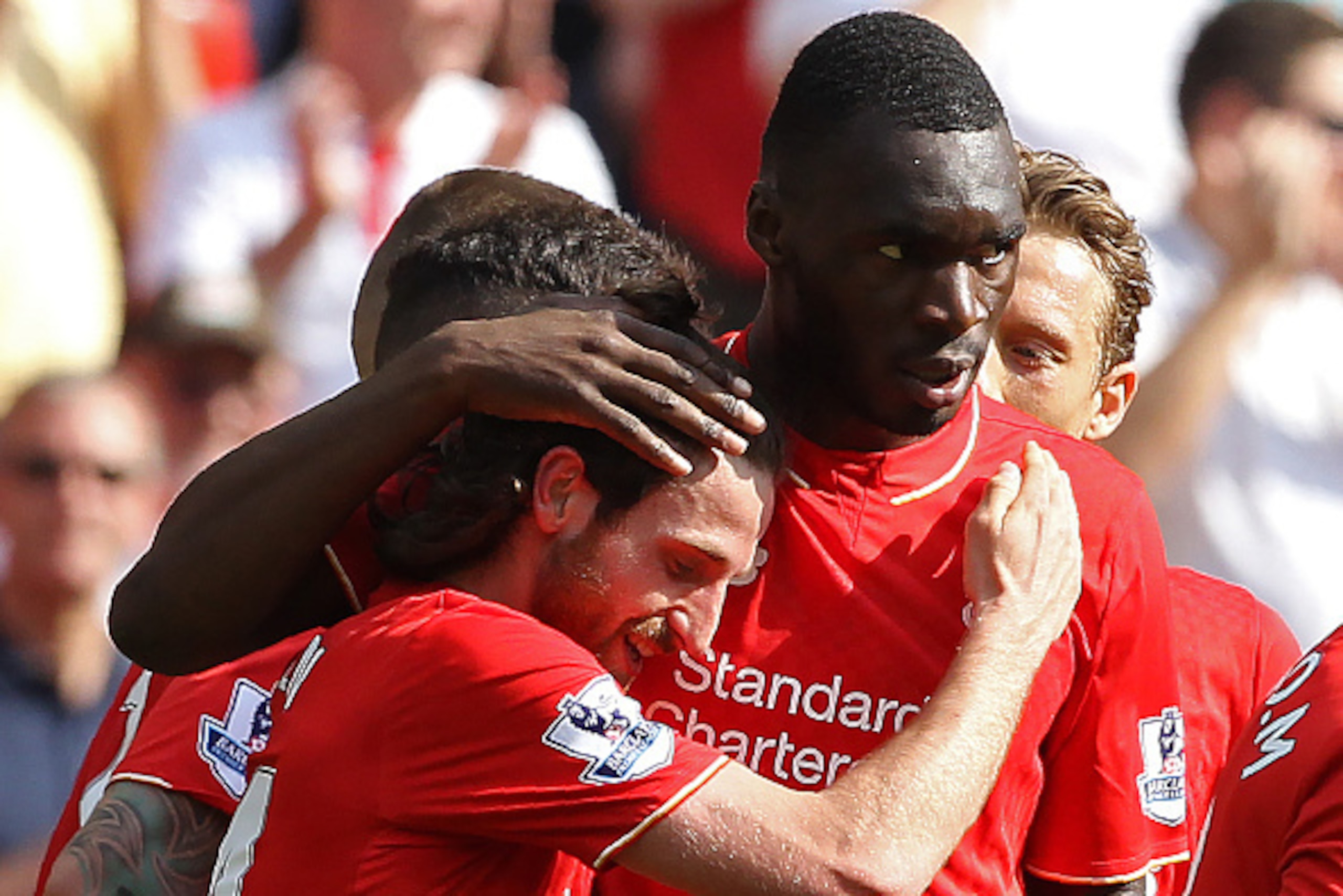 Liverpool's Welsh midfielder Joe Allen (L) celebrates scoring his team's first goal with Liverpool's Zaire-born Belgian striker Christian Benteke during the English Premier League football match between Liverpool and Watford at Anfield in Liverpool, north