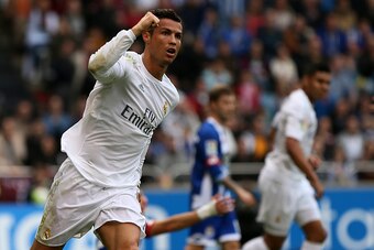 Real Madrid's Portuguese forward Cristiano Ronaldo celebrates after scoring during the Spanish league football match RC Deportivo de la Coruna vs Real Madrid CF at the Municipal de Riazor stadium in La Coruna on May 14, 2016. / AFP / CESAR MANSO        (P