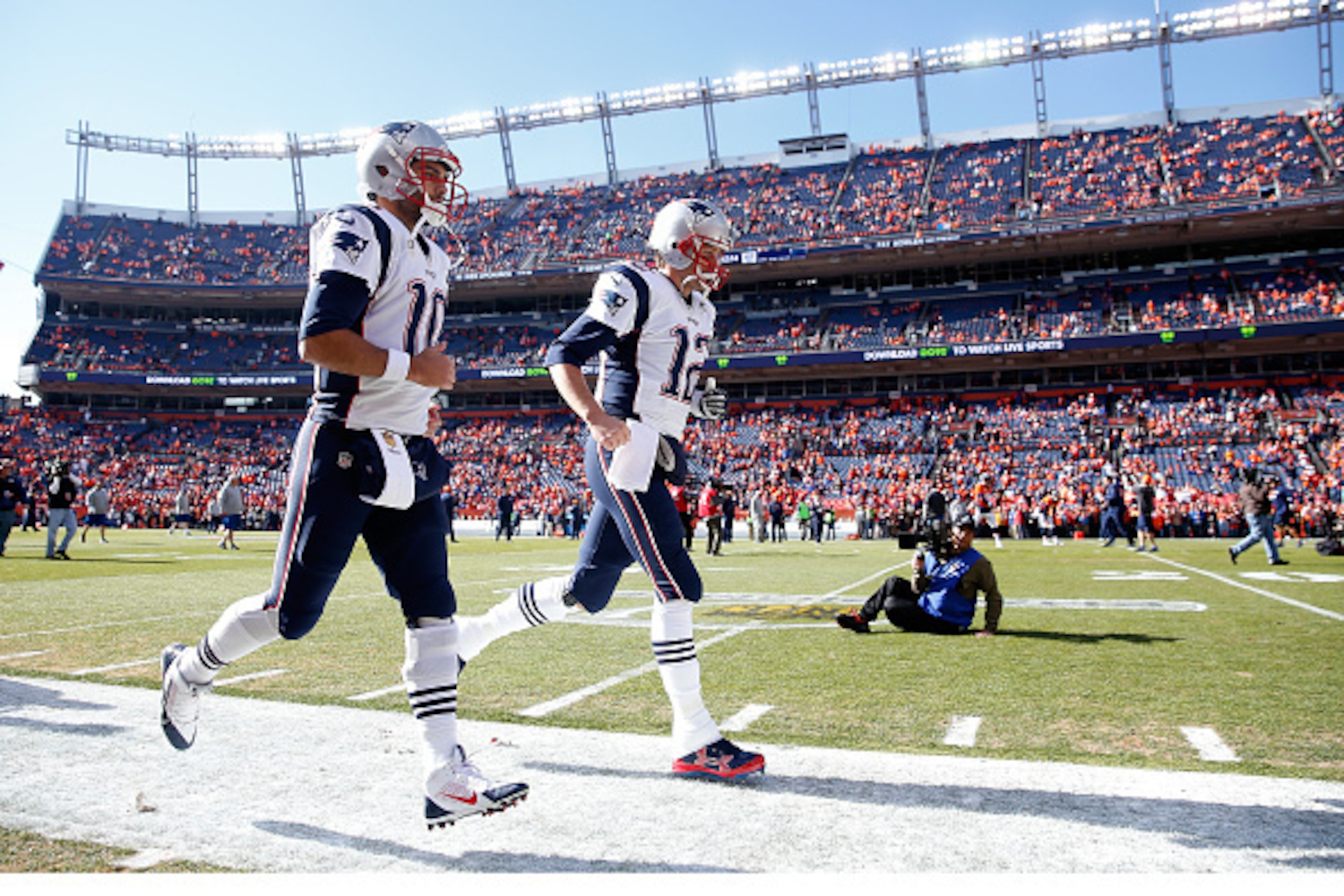 DENVER, CO - JANUARY 24:  Jimmy Garoppolo #10 and Tom Brady #12 of the New England Patriots run on to the field prior to the AFC Championship game against the Denver Broncos at Sports Authority Field at Mile High on January 24, 2016 in Denver, Colorado.  