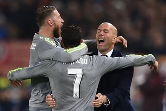 Real Madrid's Portuguese forward Cristiano Ronaldo (C) celebrates with Real Madrid's defender Sergio Ramos and Real Madrid's French coach Zinedine Zidane after scoring during the UEFA Champions League football match AS Roma vs Real Madrid on Frebruary 17,