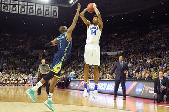 PROVIDENCE, RI - MARCH 17:  Brandon Ingram #14 of the Duke Blue Devils takes a jump shot over Chris Flemmings #1 of the North Carolina-Wilmington Seahawks during a first round NCAA College Basketball Tournament game at Dunkin' Donuts Center on March 17, 2