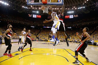 OAKLAND, CA - MAY 03:  Harrison Barnes #40 of the Golden State Warriors dunks on Ed Davis #17 of the Portland Trail Blazers during Game Two of the Western Conference Semifinals during the 2016 NBA Playoffs on May 3, 2016 at Oracle Arena in Oakland, Califo