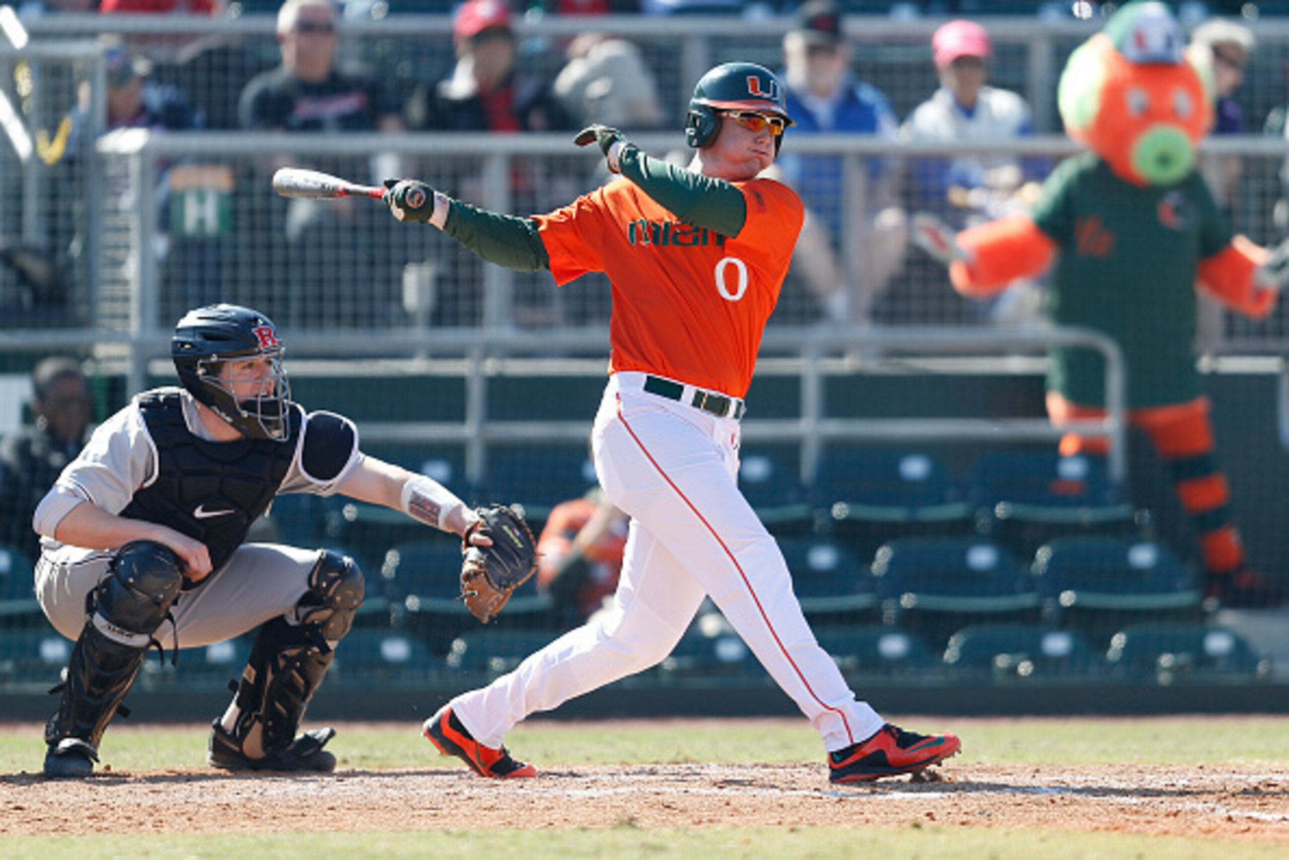 CORAL GABLES, FL - FEBRUARY 14: Zack Collins #0 of the Miami Hurricanes hits a double scoring three runs against the Rutgers Scarlet Knights in the second inning on February 14, 2015 at Alex Rodriguez Park at Mark Light Field in Coral Gables, Florida. Mia CORAL GABLES, FL - FEBRUARY 14: Zack Collins #0 of the Miami Hurricanes hits a double scoring three runs against the Rutgers Scarlet Knights in the second inning on February 14, 2015 at Alex Rodriguez Park at Mark Light Field in Coral Gables, Florida. Mia