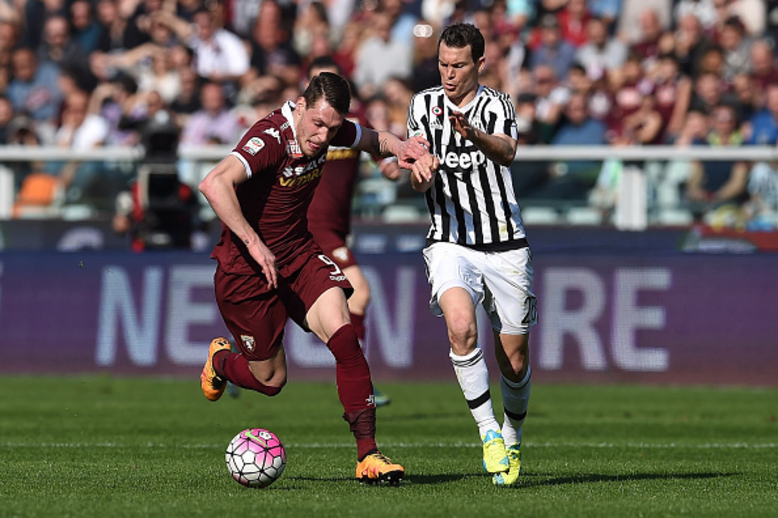 TURIN, ITALY - MARCH 20:  Andrea Belotti (L) of Torino FC is challenged by Stephan Lichtsteiner of Juventus FC during the Serie A match between Torino FC and Juventus FC at Stadio Olimpico di Torino on March 20, 2016 in Turin, Italy.  (Photo by Valerio Pe