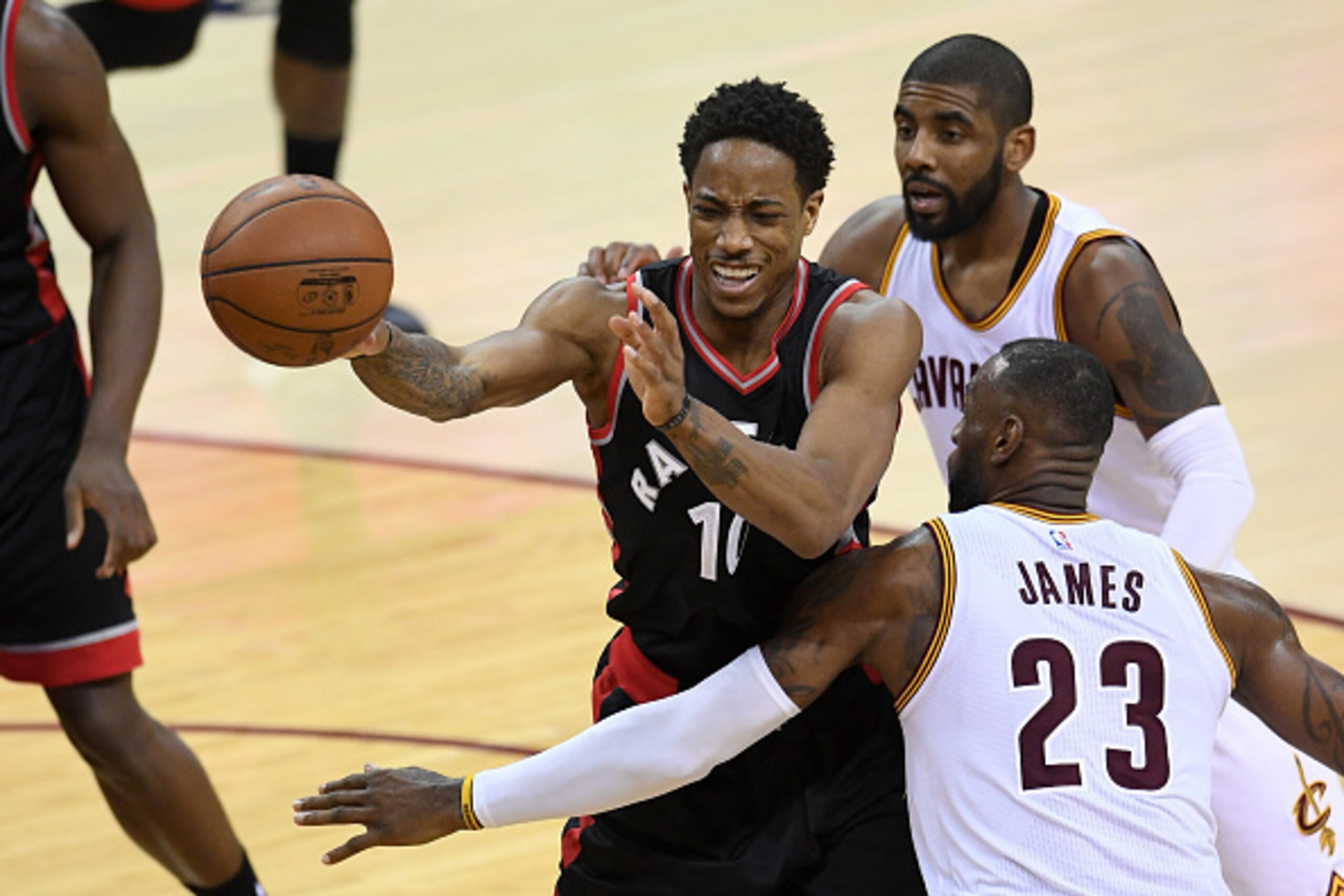 CLEVELAND, OH - MAY 17: LeBron James #23 and Kyrie Irving #2 of the Cleveland Cavaliers defend DeMar DeRozan #10 of the Toronto Raptors in the second half in game one of the Eastern Conference Finals during the 2016 NBA Playoffs at Quicken Loans Arena on 