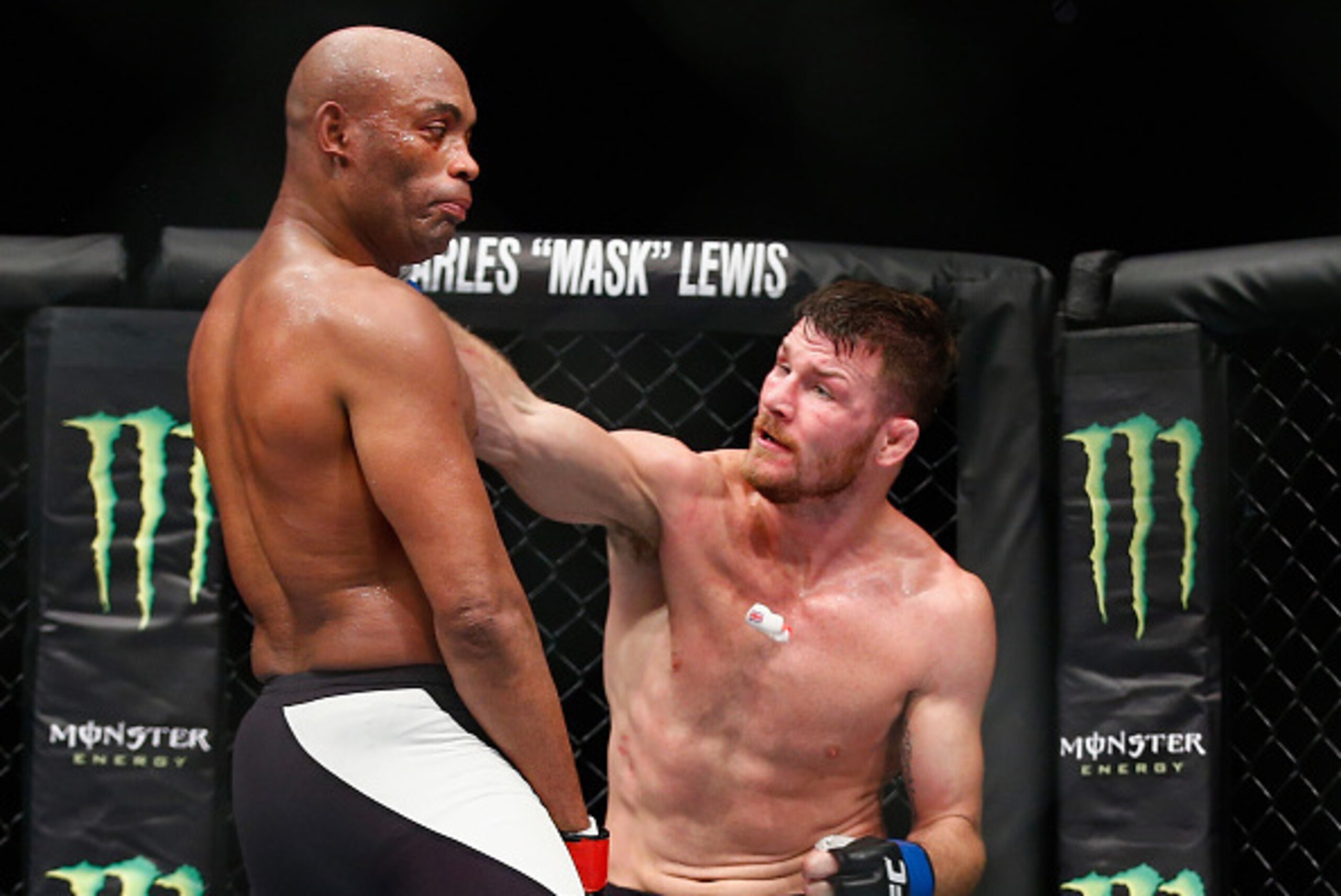 LONDON, ENGLAND - FEBRUARY 27:  Michael Bisping of Great Britain (R) knocks out the gumshield of Anderson Silva of Brazil which leads to confusion as Silva fights on without his gumshield during the Middleweight Bout of the UFC Fight Night  at The O2 Aren