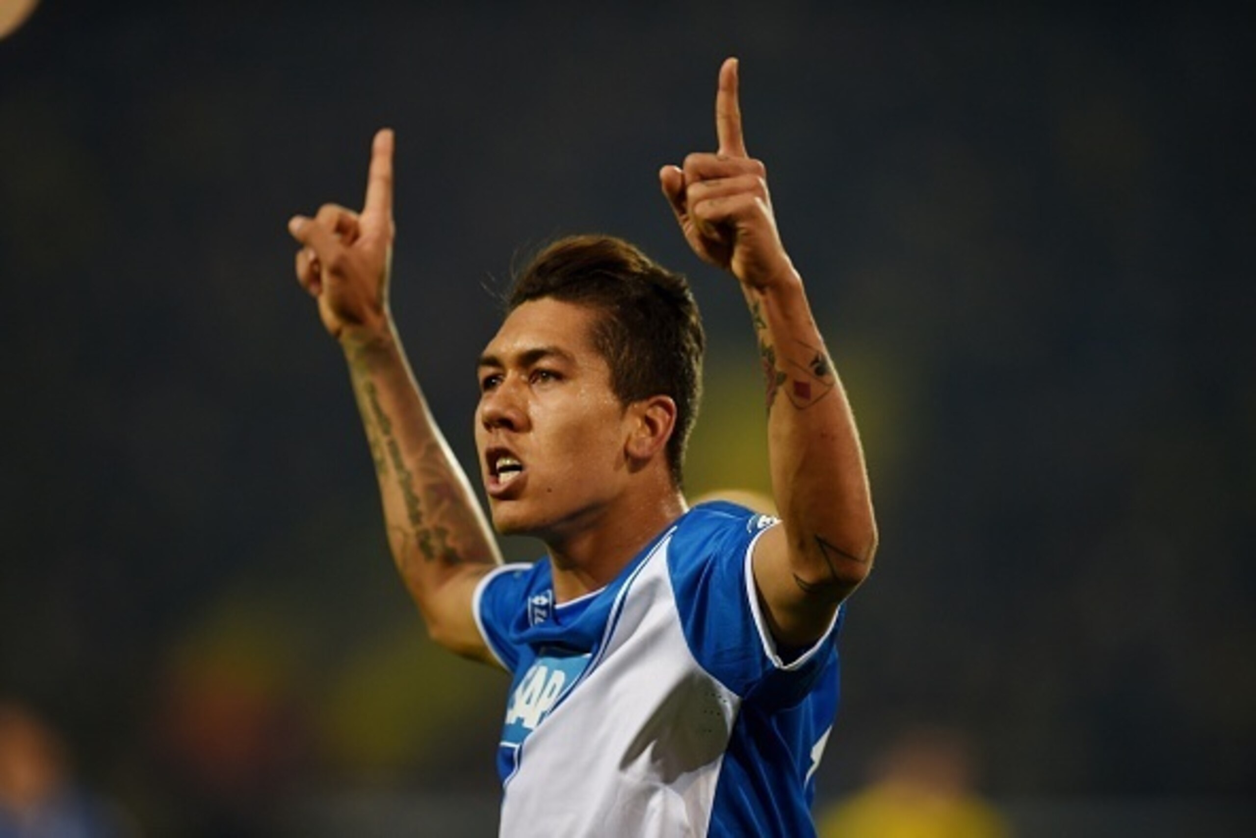 Hoffenheim's Brazilian midfielder Roberto Firmino celebrates during the German Football Cup DFB Pokal quarter-final match between Borussia Dortmund and 1899 Hoffenheim in Dortmund, western Germany, on April 7, 2015. AFP PHOTO / PATRIK STOLLARZ  DFB RULES 