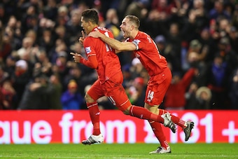 LIVERPOOL, ENGLAND - JANUARY 13:  Roberto Firmino (L) of Liverpool celebrates scoring his team's second goal with his team mate Jordan Henderson (R)  during the Barclays Premier League match between Liverpool and Arsenal at Anfield on January 13, 2016 in 