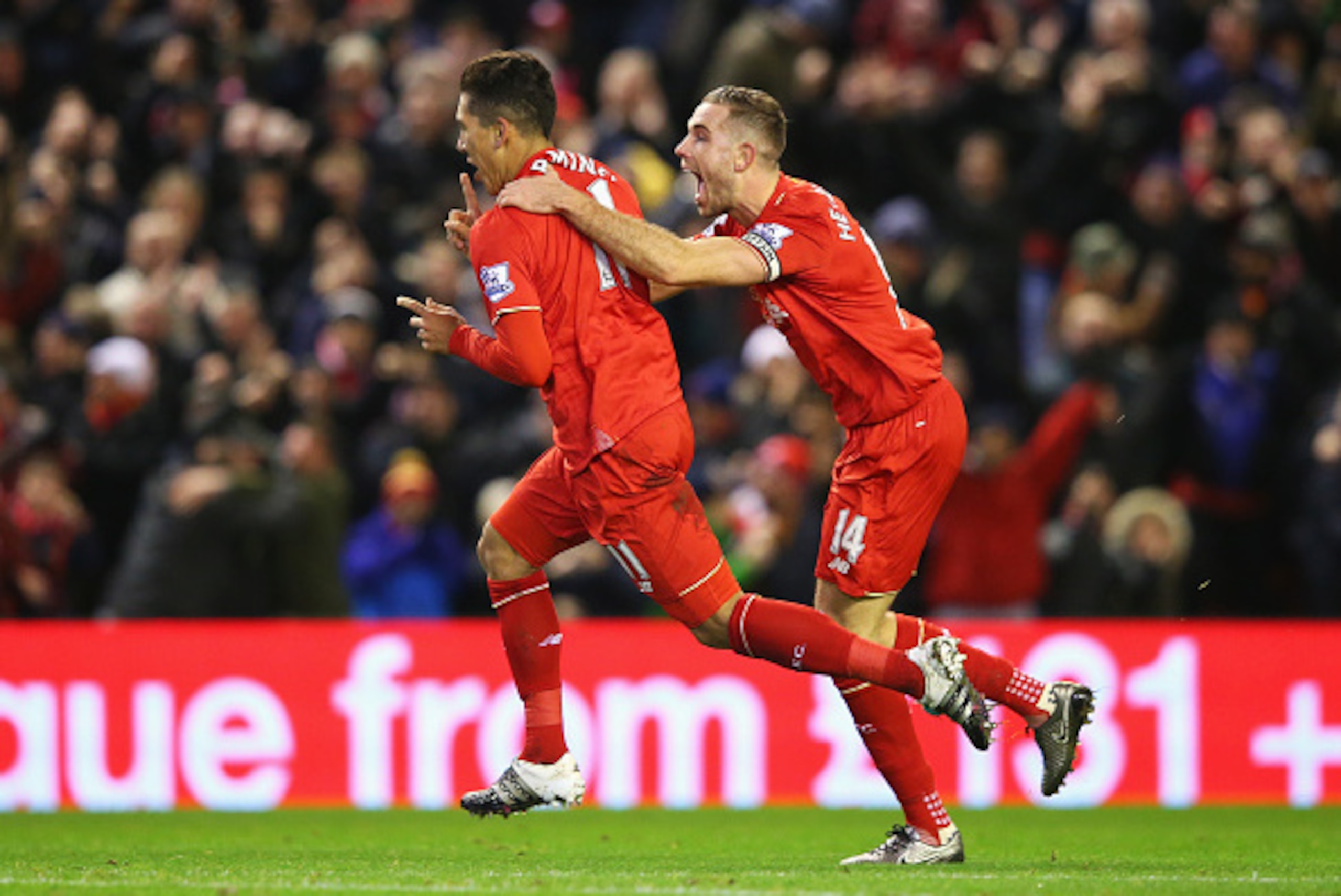 LIVERPOOL, ENGLAND - JANUARY 13:  Roberto Firmino (L) of Liverpool celebrates scoring his team's second goal with his team mate Jordan Henderson (R)  during the Barclays Premier League match between Liverpool and Arsenal at Anfield on January 13, 2016 in 